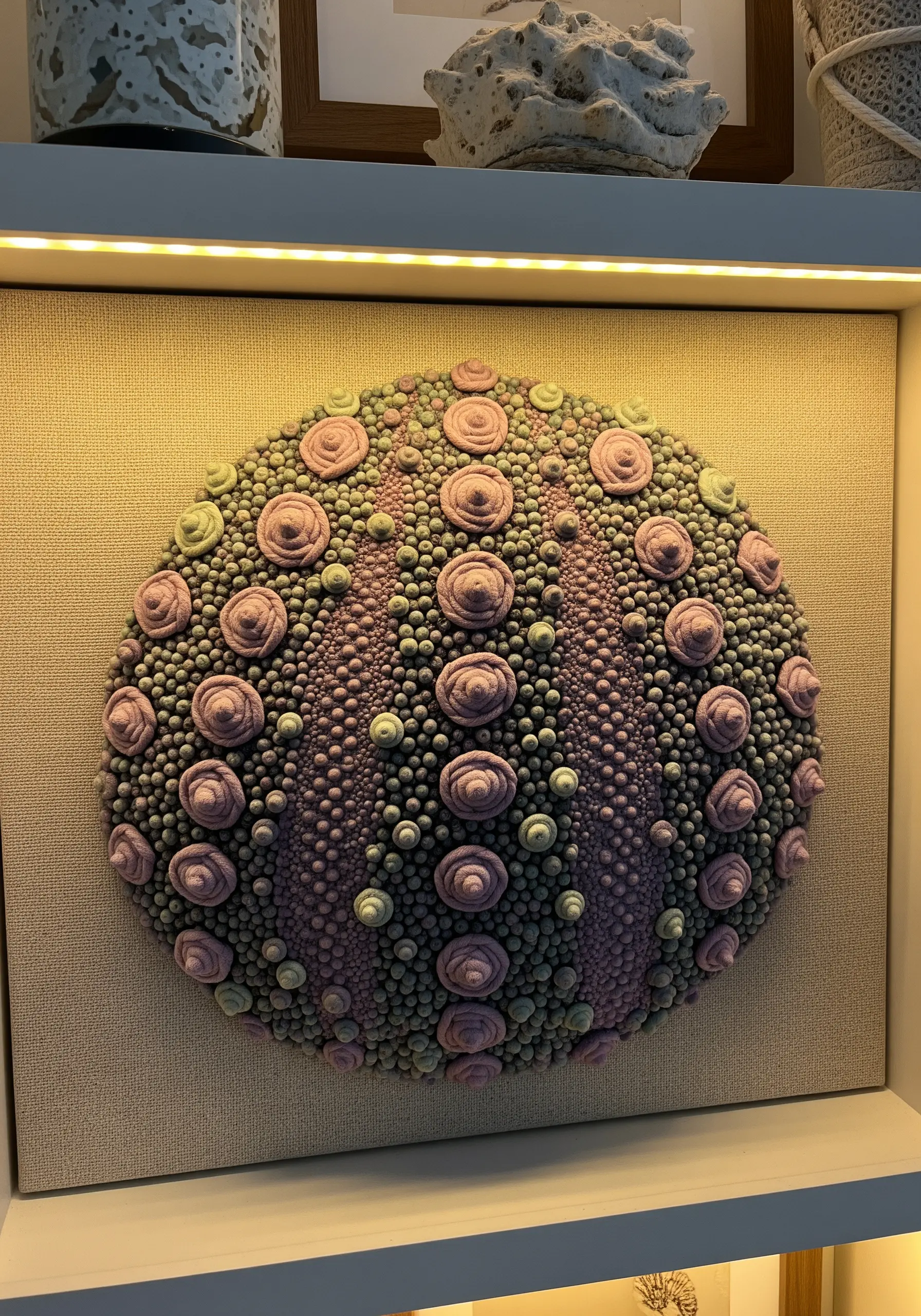 A 3D sea urchin texture made with pink and green French knots and bullion roses.