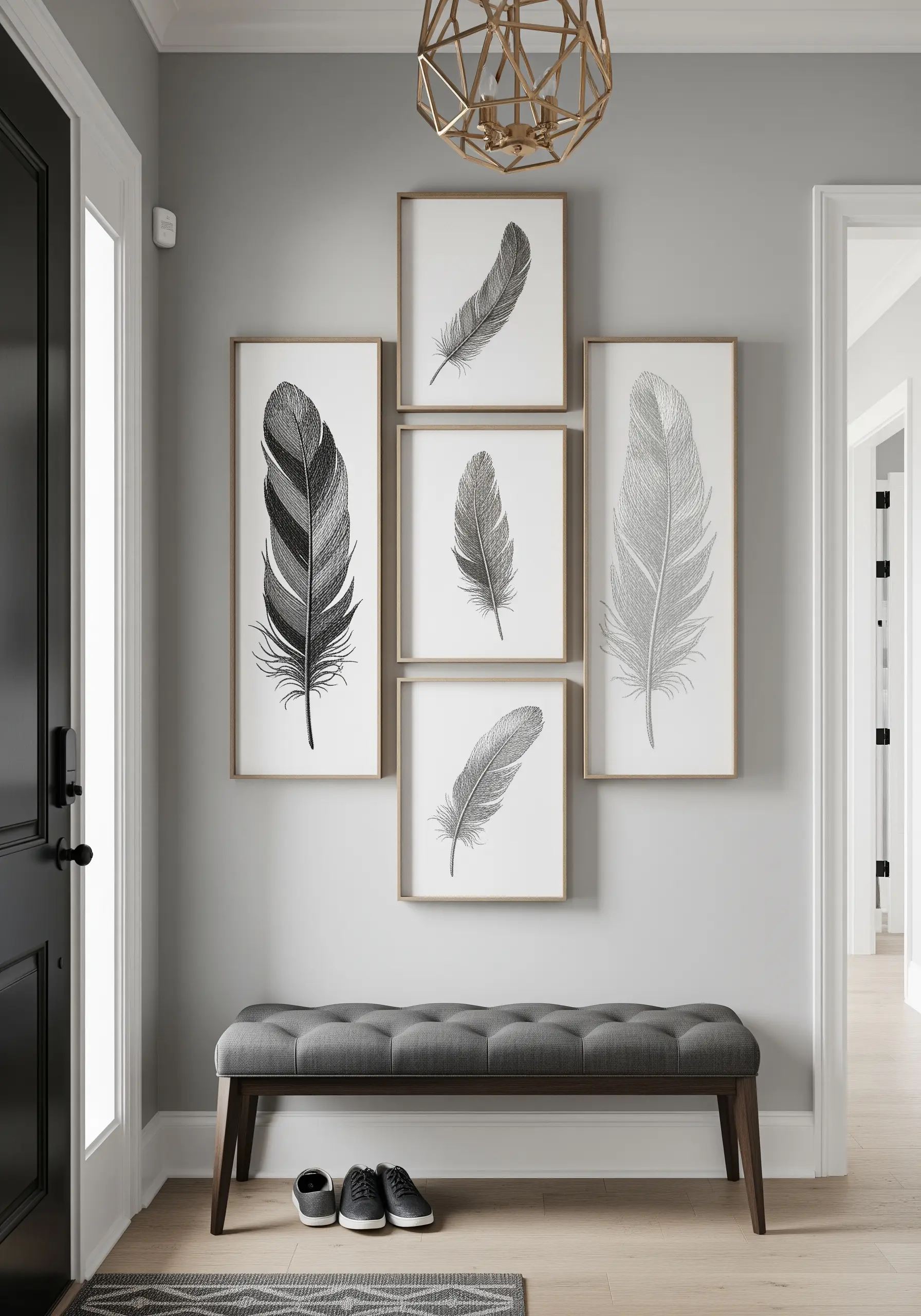 A gallery wall of five framed feathers embroidered with silver and grey metallic threads.