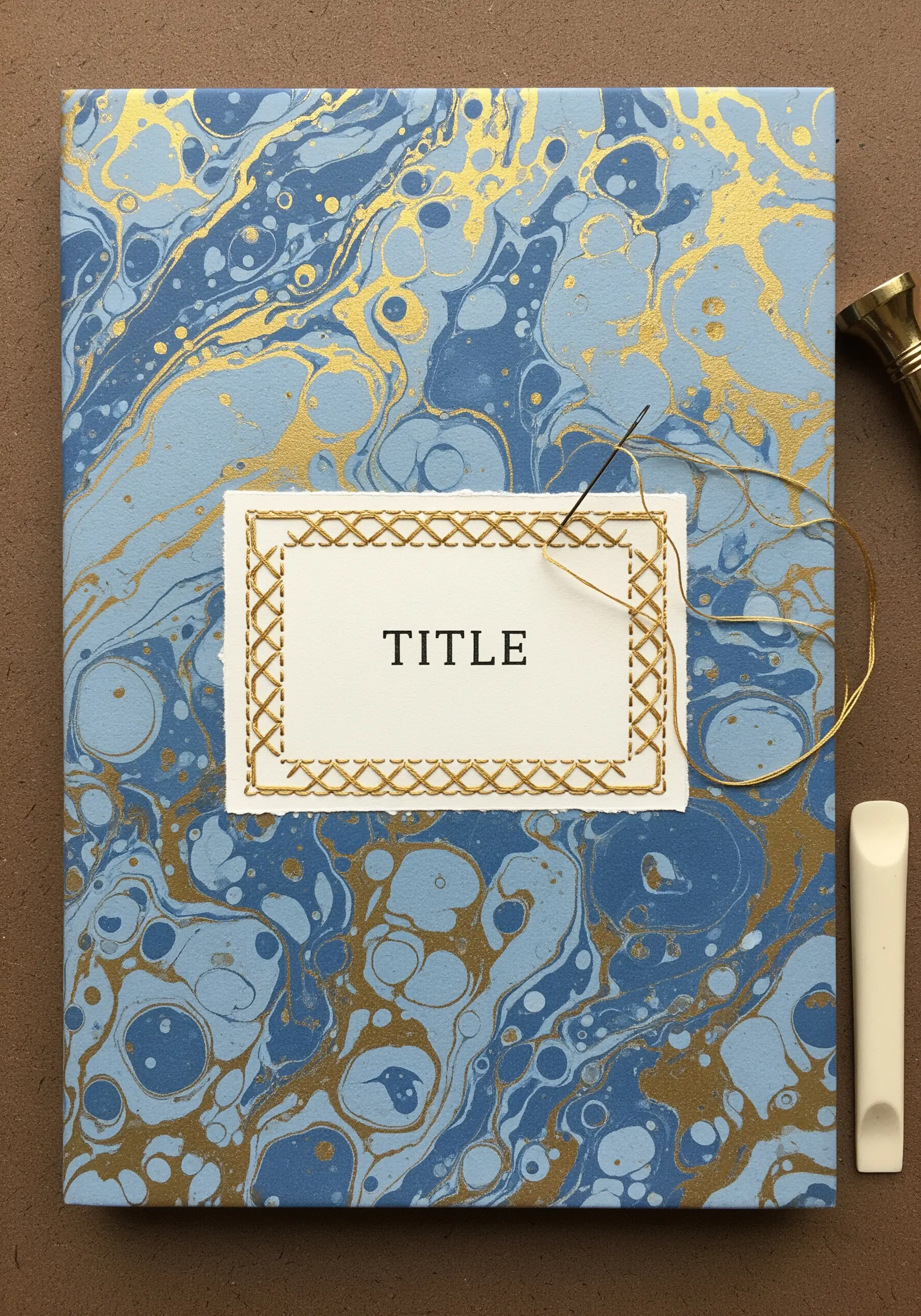 A marbled blue book cover with a central title label framed by a gold chevron stitch border.