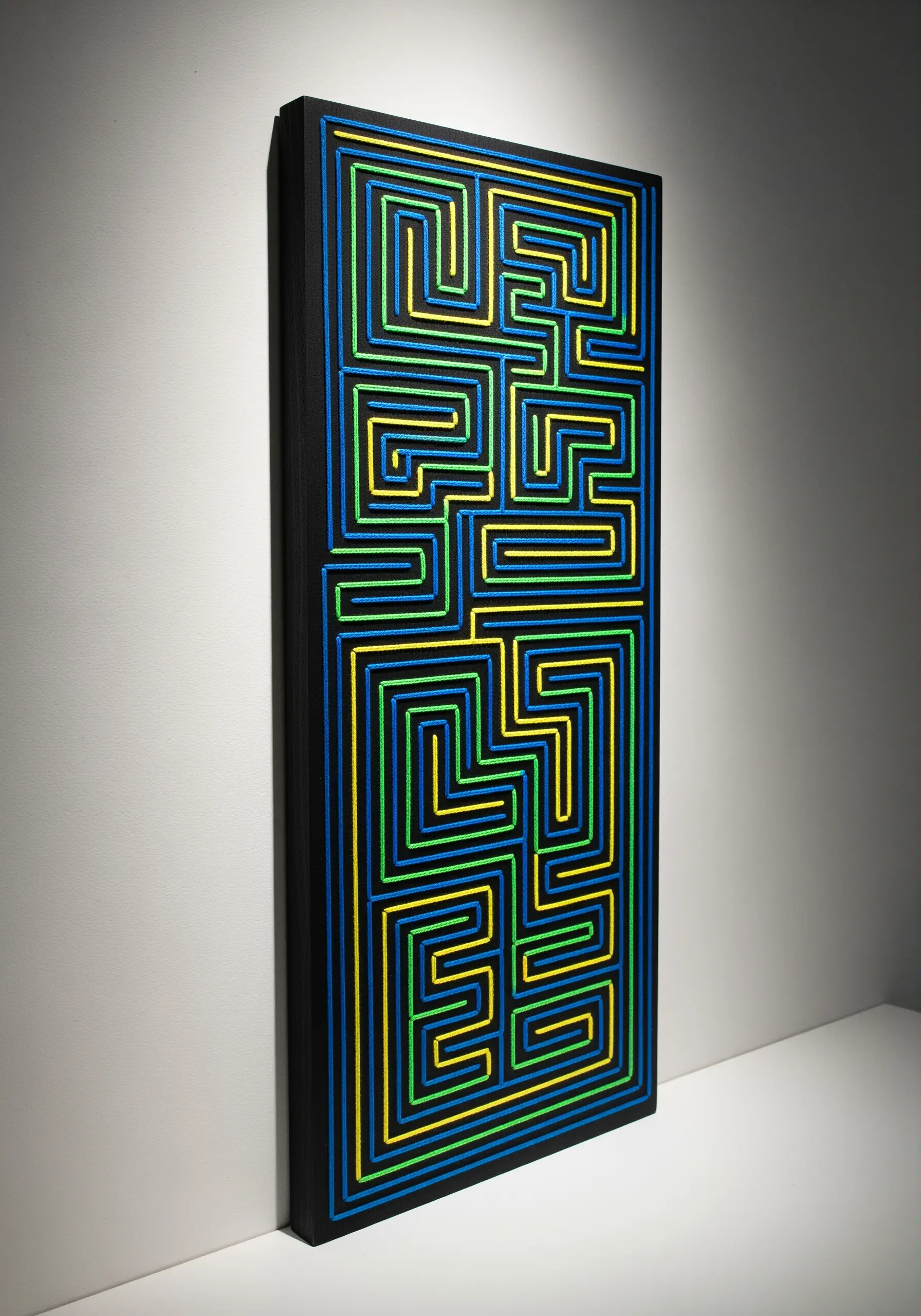 Geometric maze-like string art in bright blue, yellow, and green on a black panel.