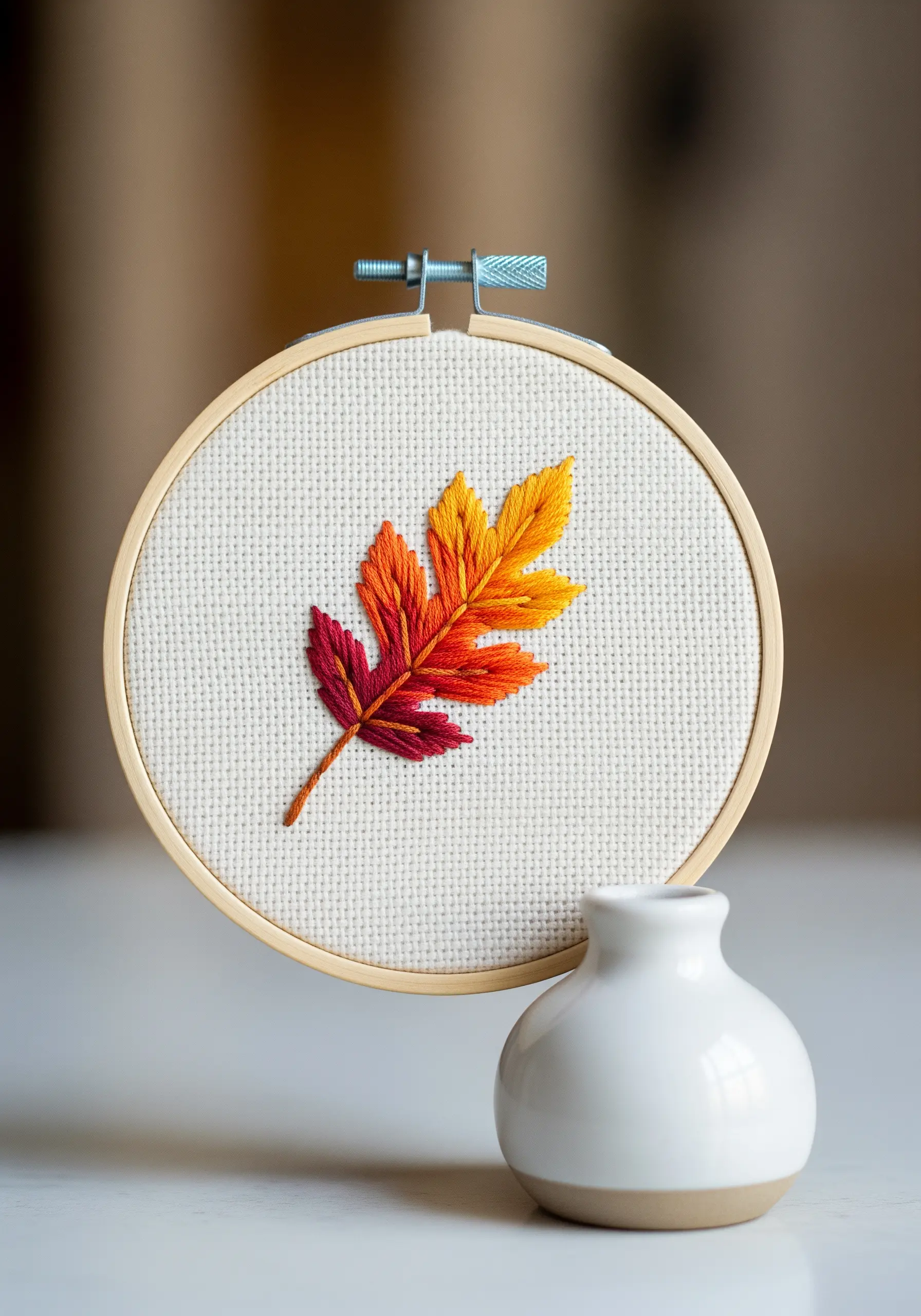 Autumn leaf embroidered with a smooth red, orange, and yellow gradient.