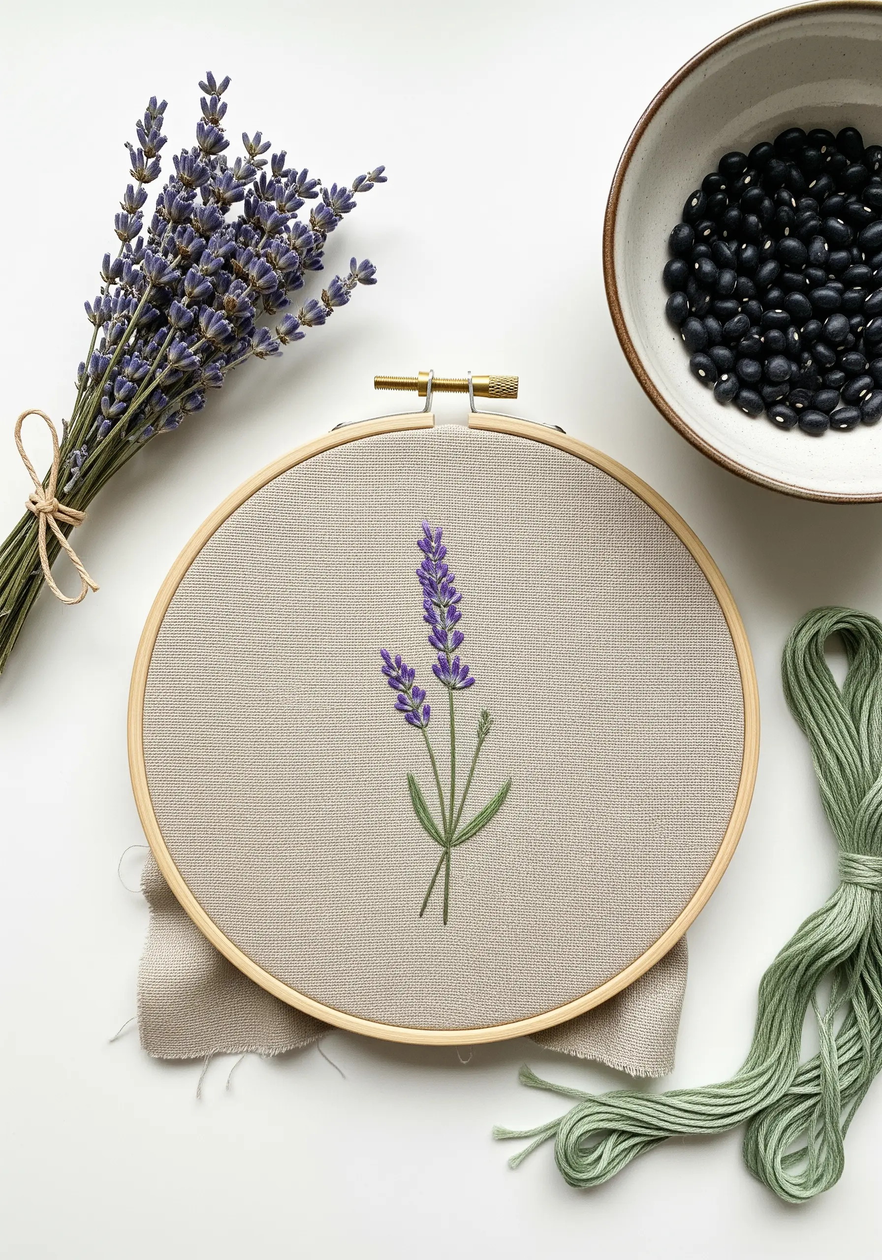 Minimalist lavender embroidery stitched with naturally dyed purple and green threads in a hoop.