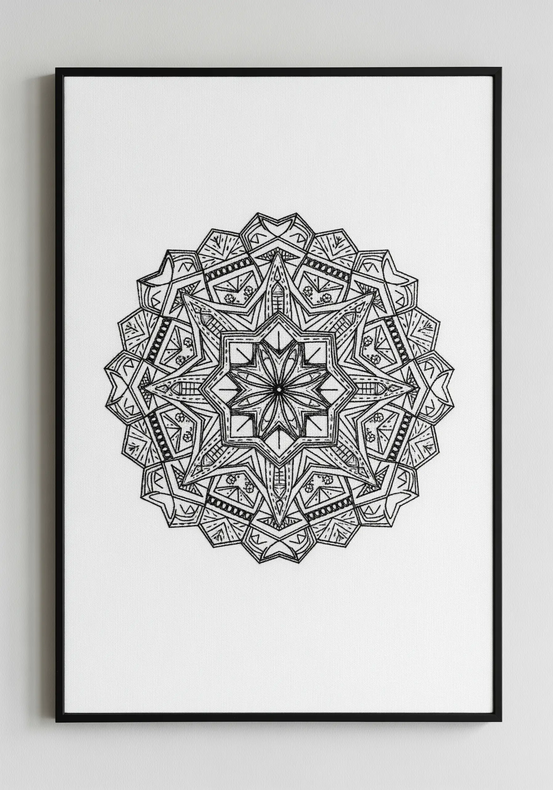 A highly intricate, geometric blackwork mandala stitched in black thread on white fabric.