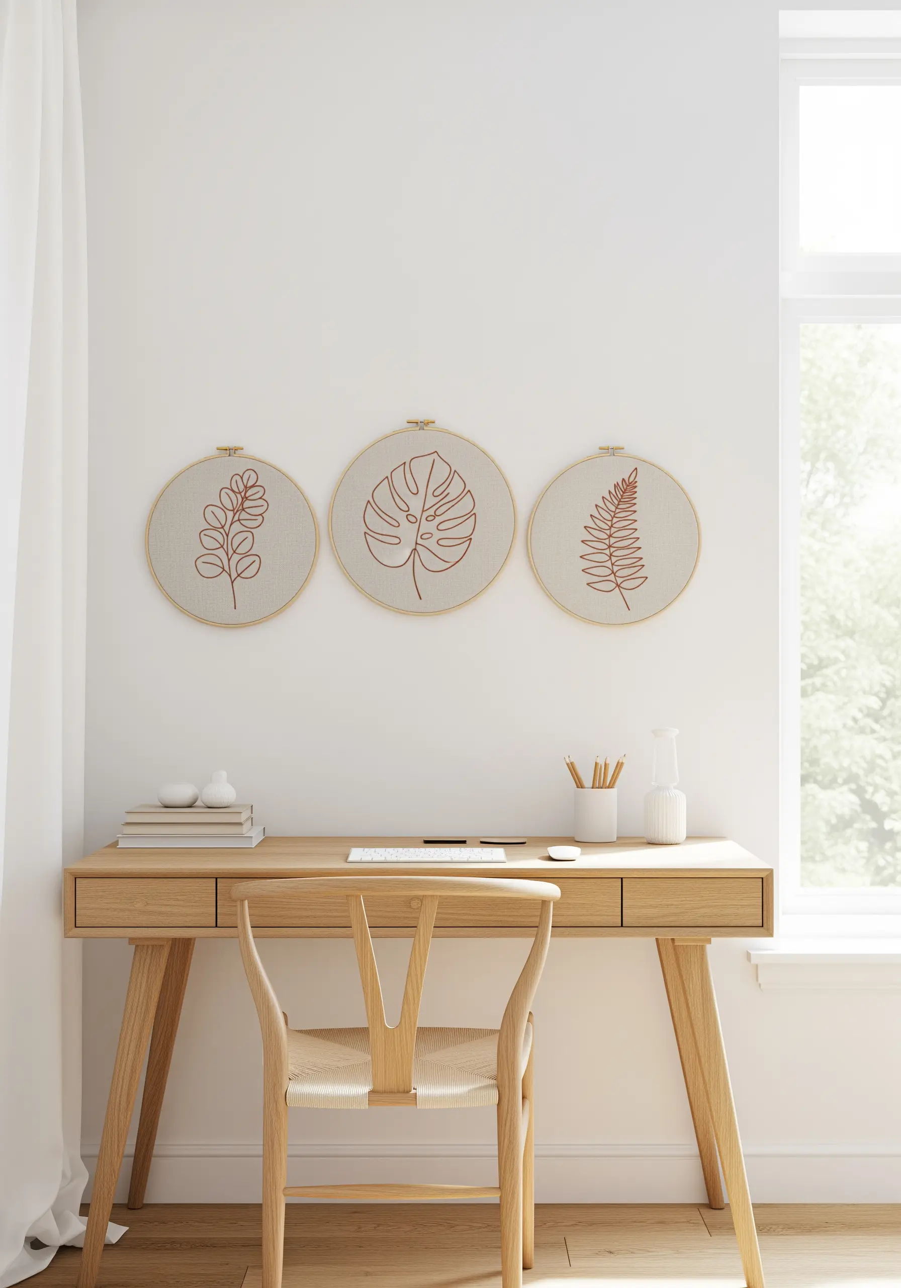 Trio of minimalist leaf and monstera outlines stitched in copper thread on neutral linen fabric.