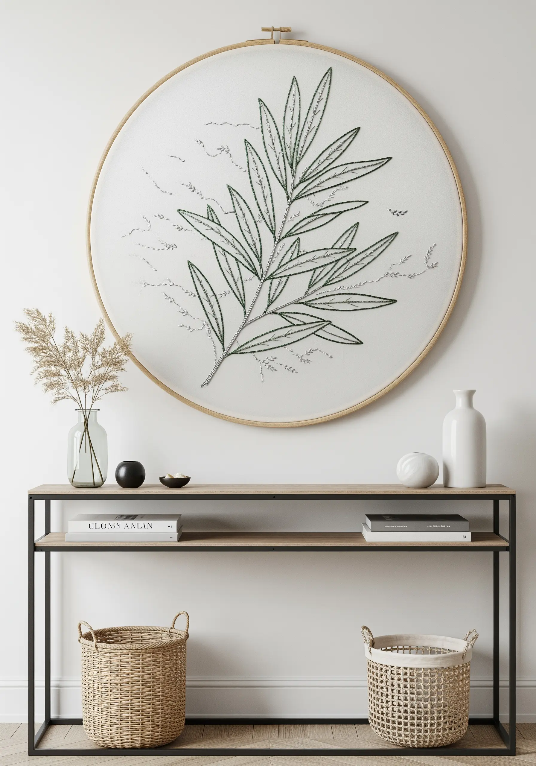 An oversized embroidery hoop featuring a large, minimalist olive branch as statement wall art.