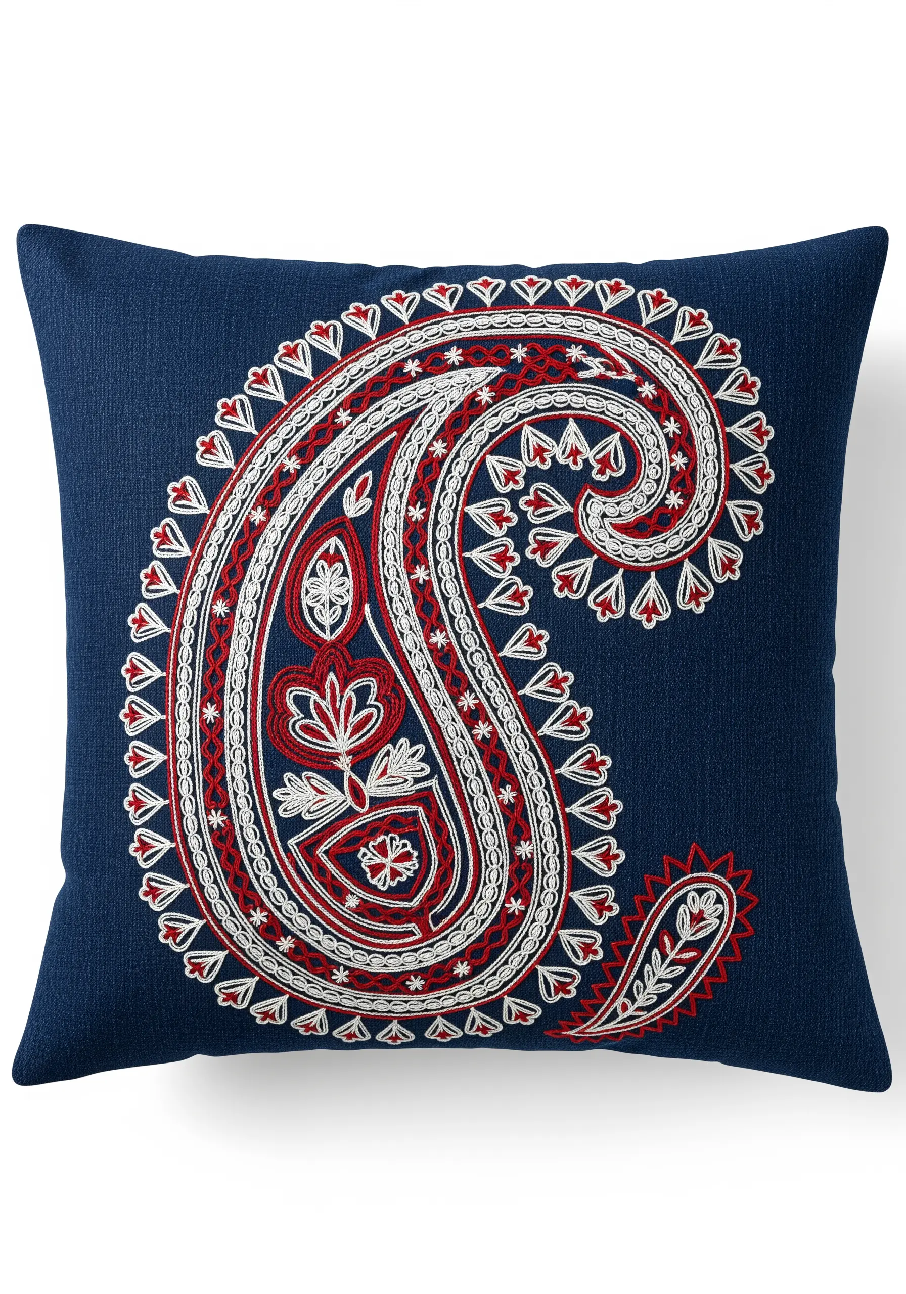 A large paisley motif in red and white on a blue cushion, filled with varied stitches