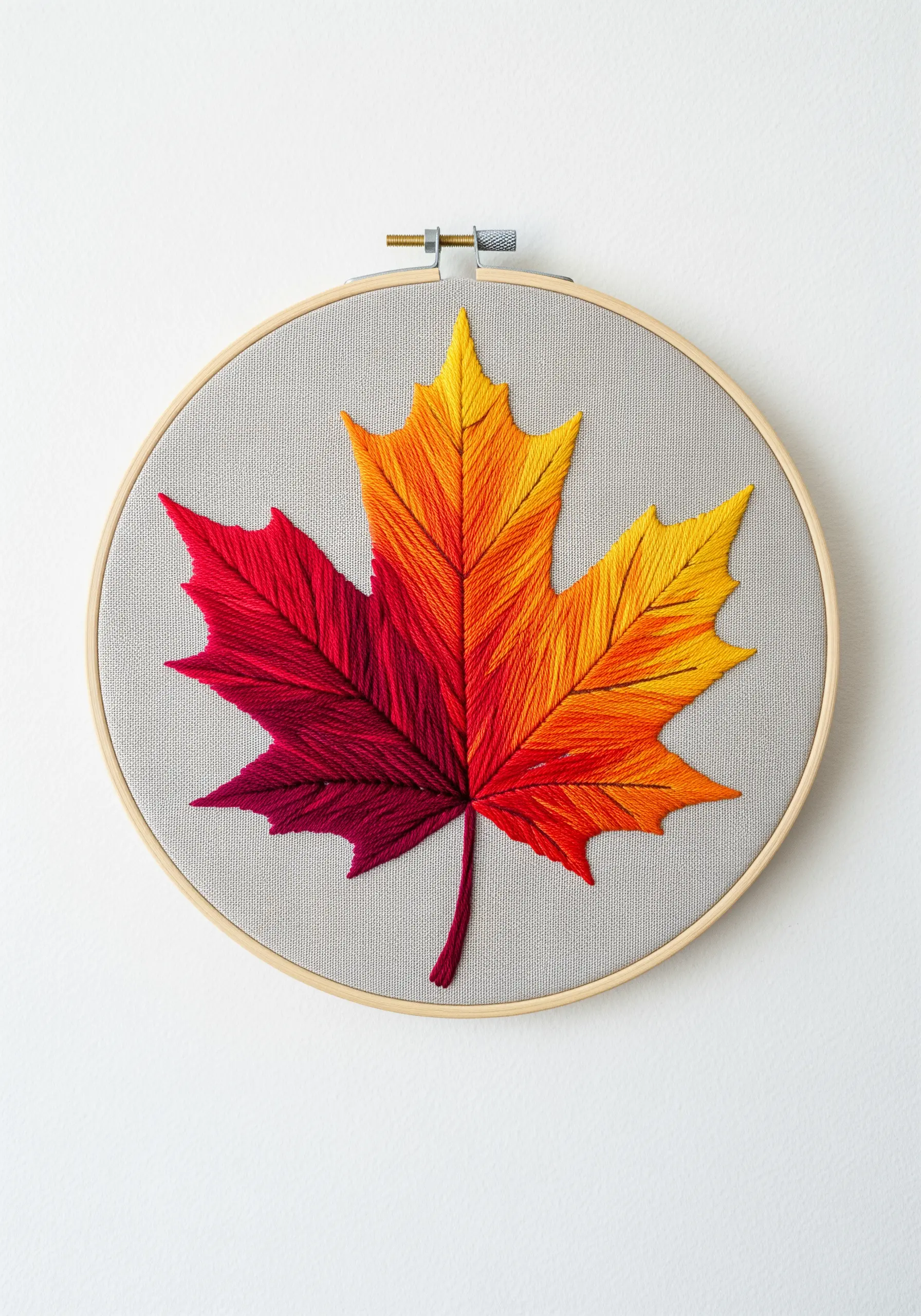 A maple leaf with a perfect red-to-orange-to-yellow gradient using long-and-short stitch.