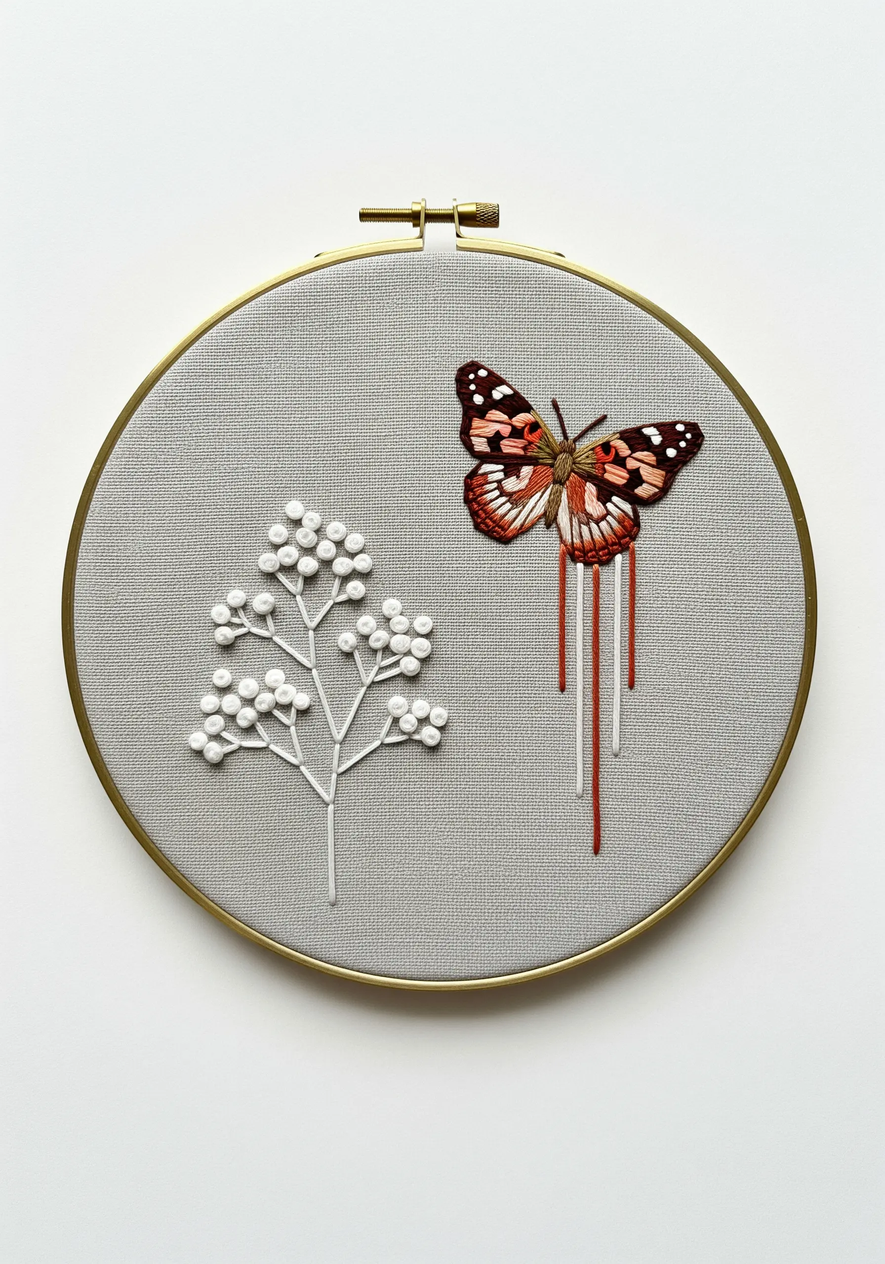 Asymmetrical embroidery with a painted lady butterfly and a white abstract berry branch.