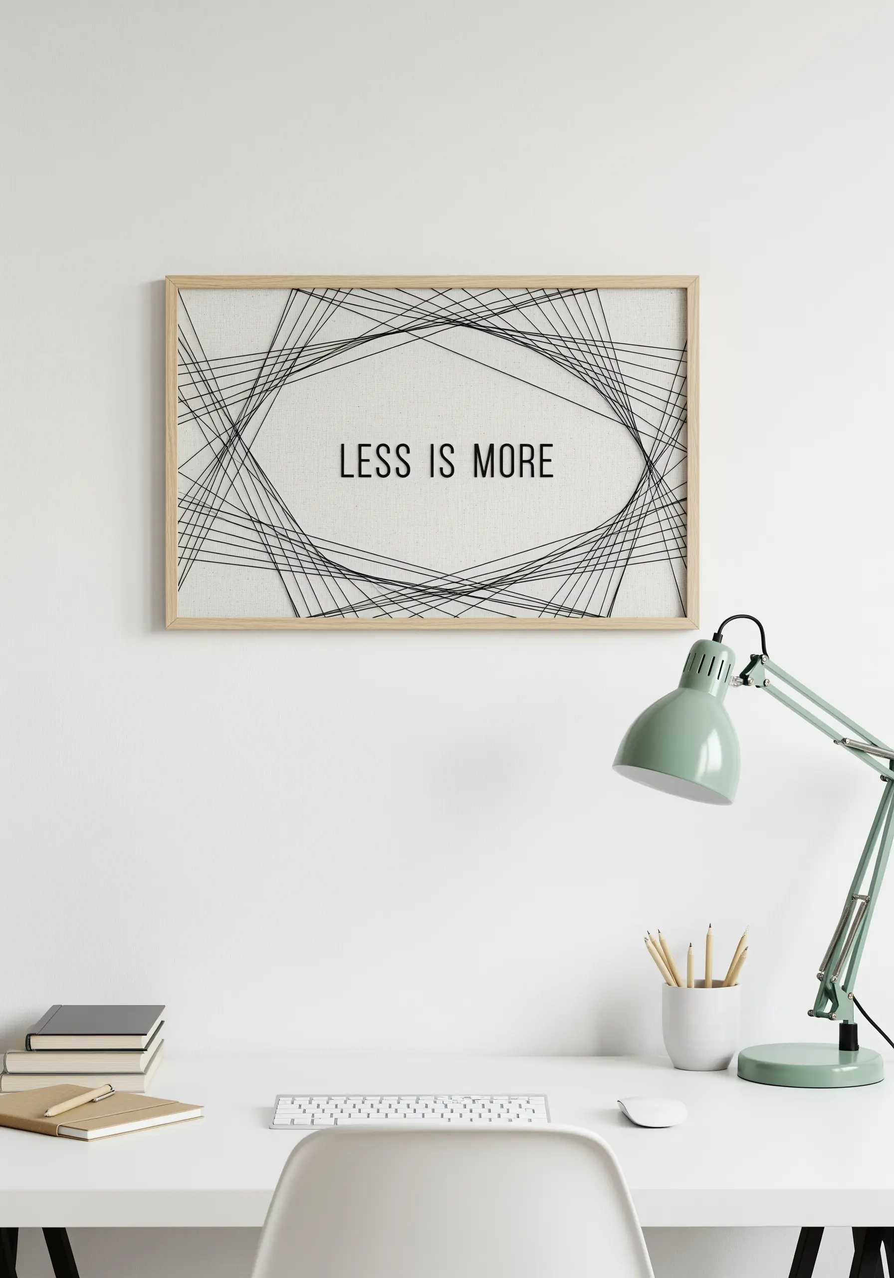 Minimalist string art with black thread in an abstract shape on light fabric. 'LESS IS MORE.'