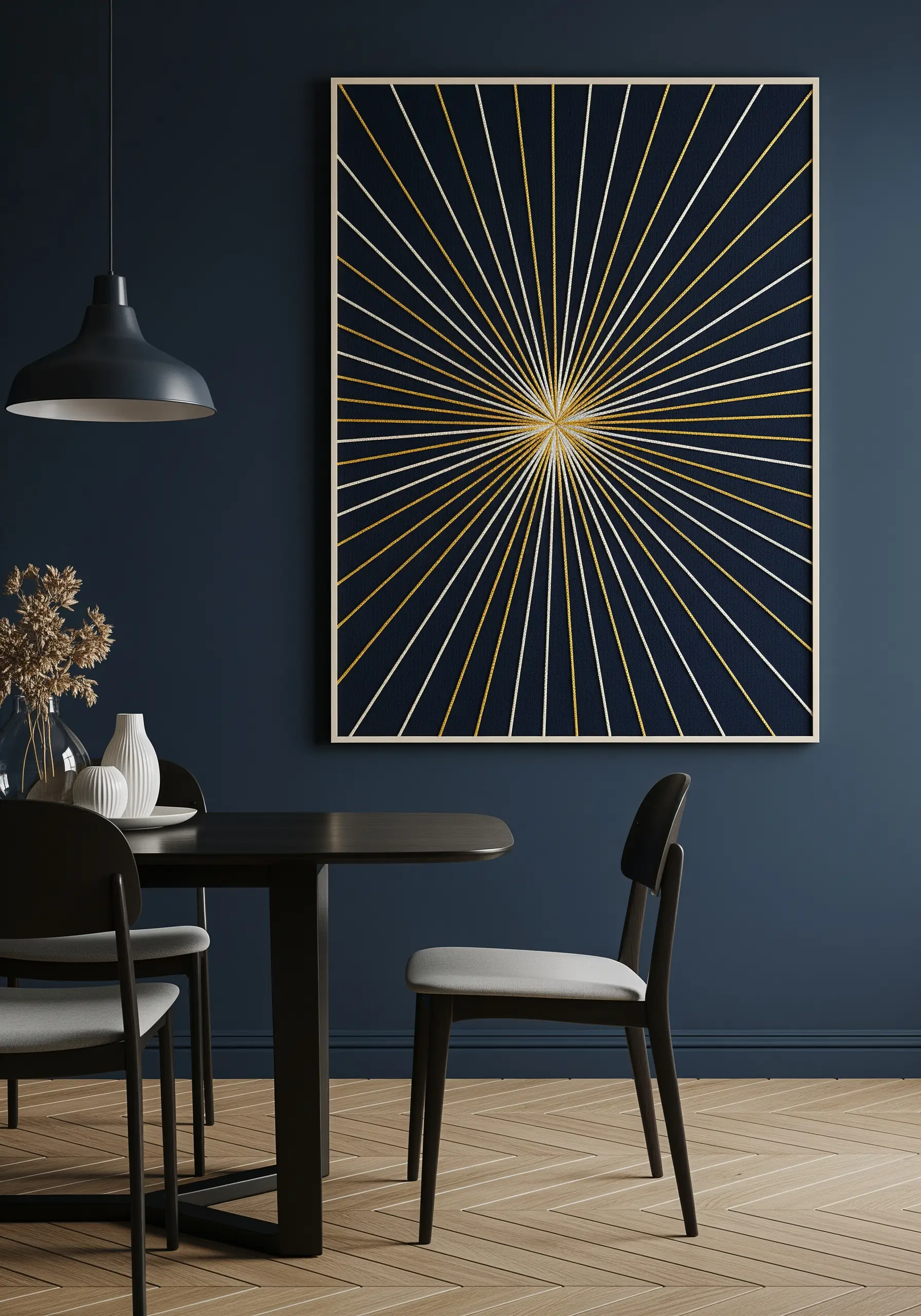A large framed piece of a sunburst pattern in gold and white thread on navy fabric.
