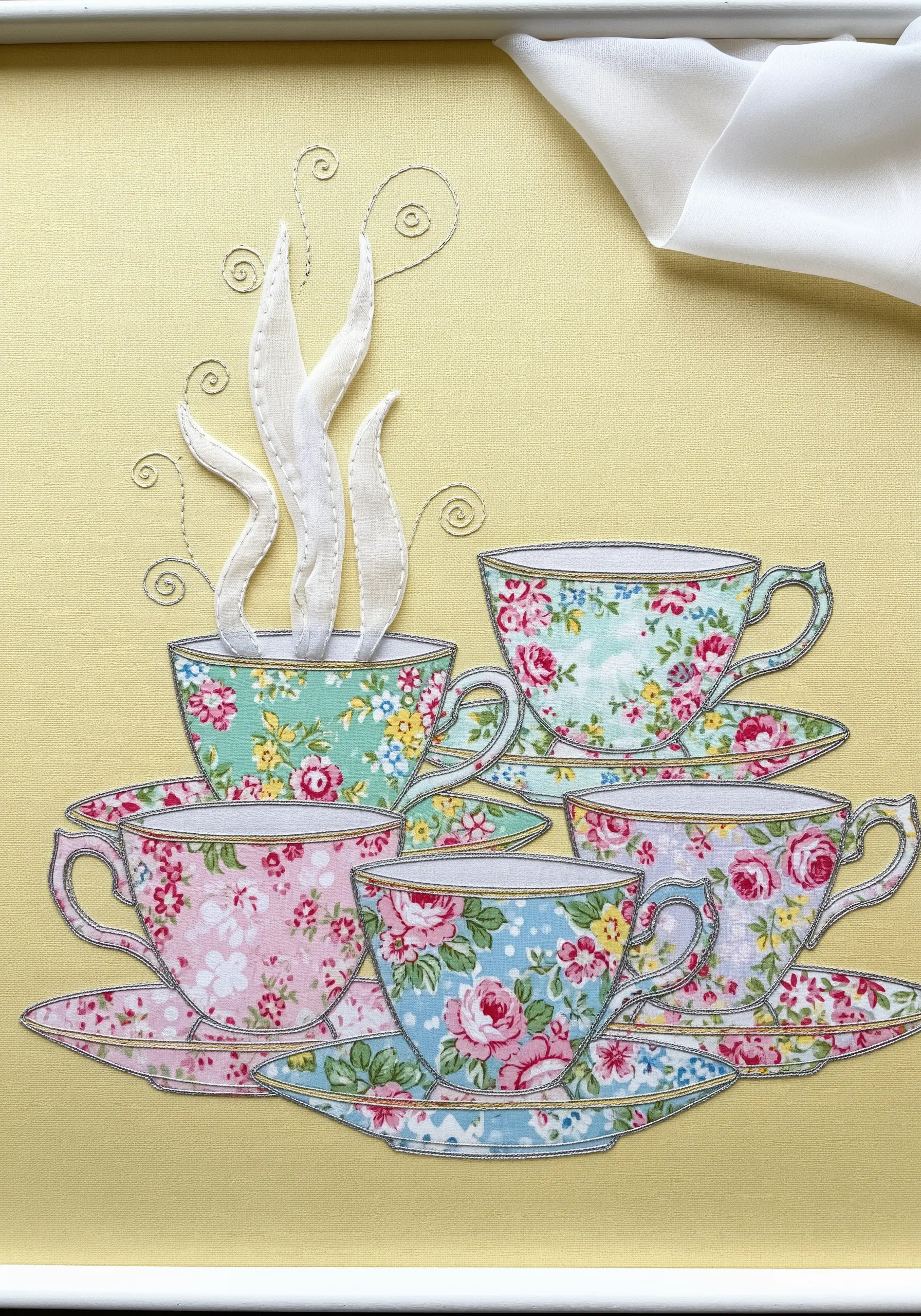 Appliqué of stacked floral teacups, created by fussy-cutting patterned fabrics.