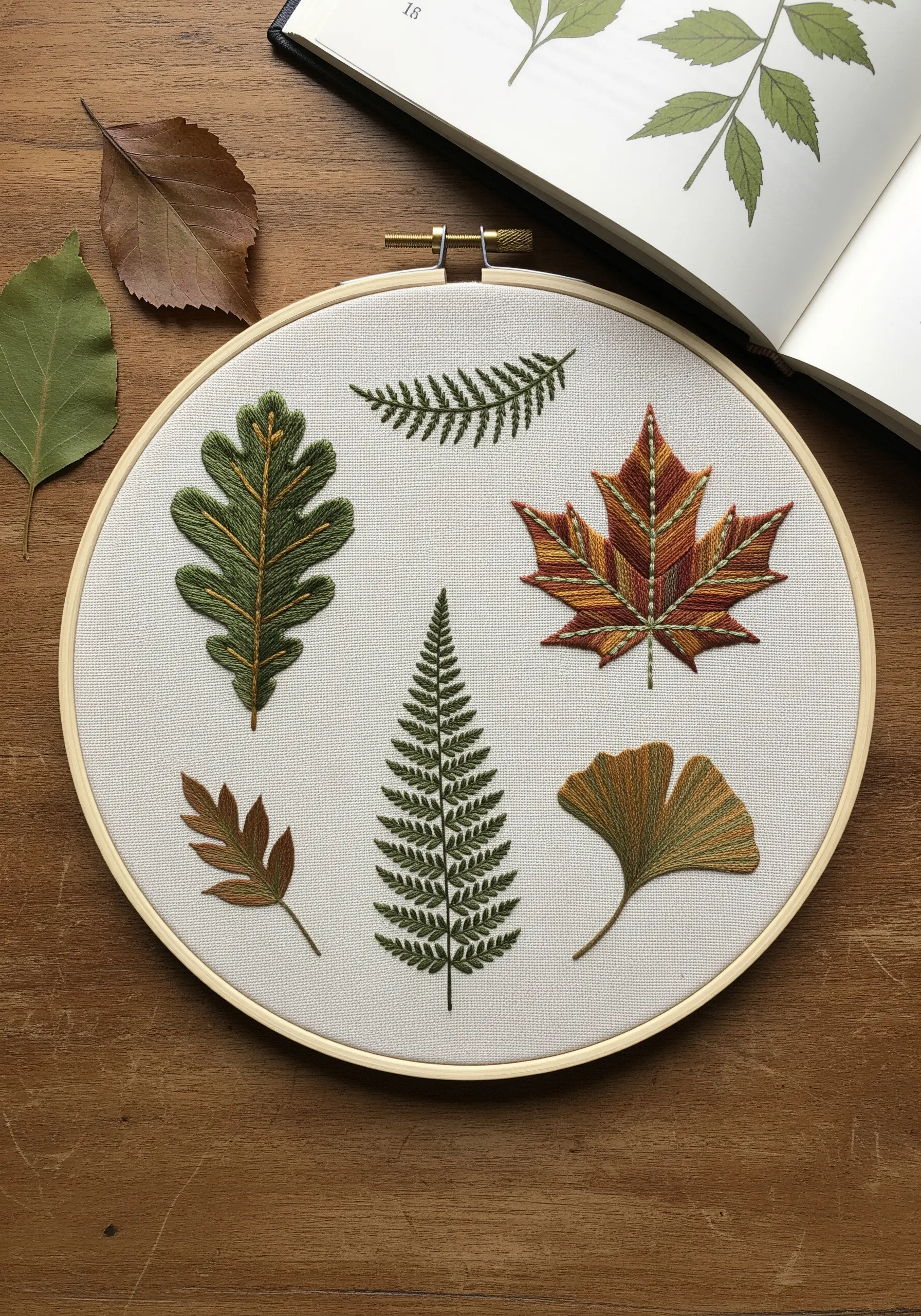 Embroidery sampler of autumn leaves with detailed color blending and veins.
