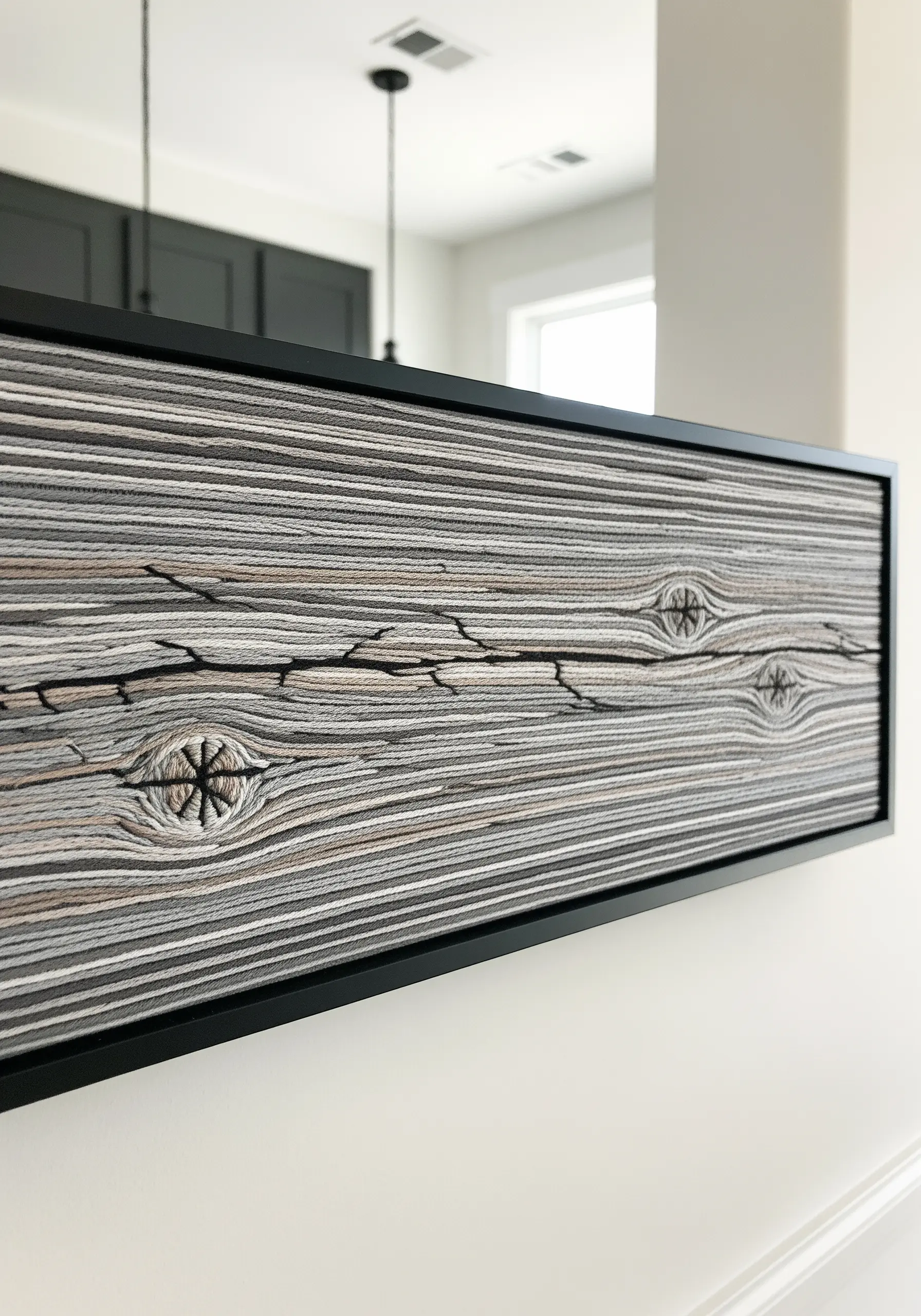 Framed embroidery of realistic wood grain using long straight stitches in neutral tones.