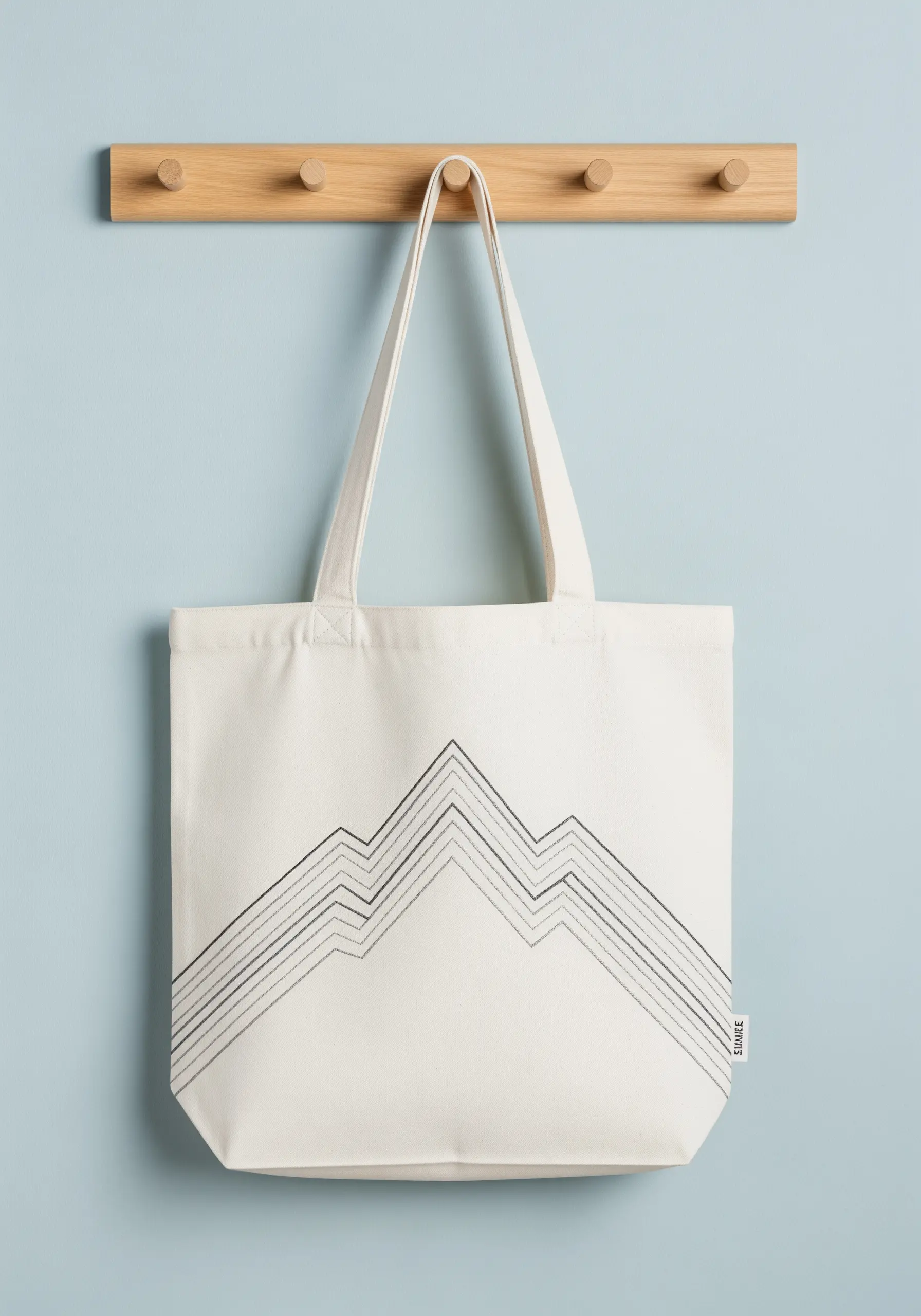 Abstract mountain range with parallel lines embroidered in varying thread weights.