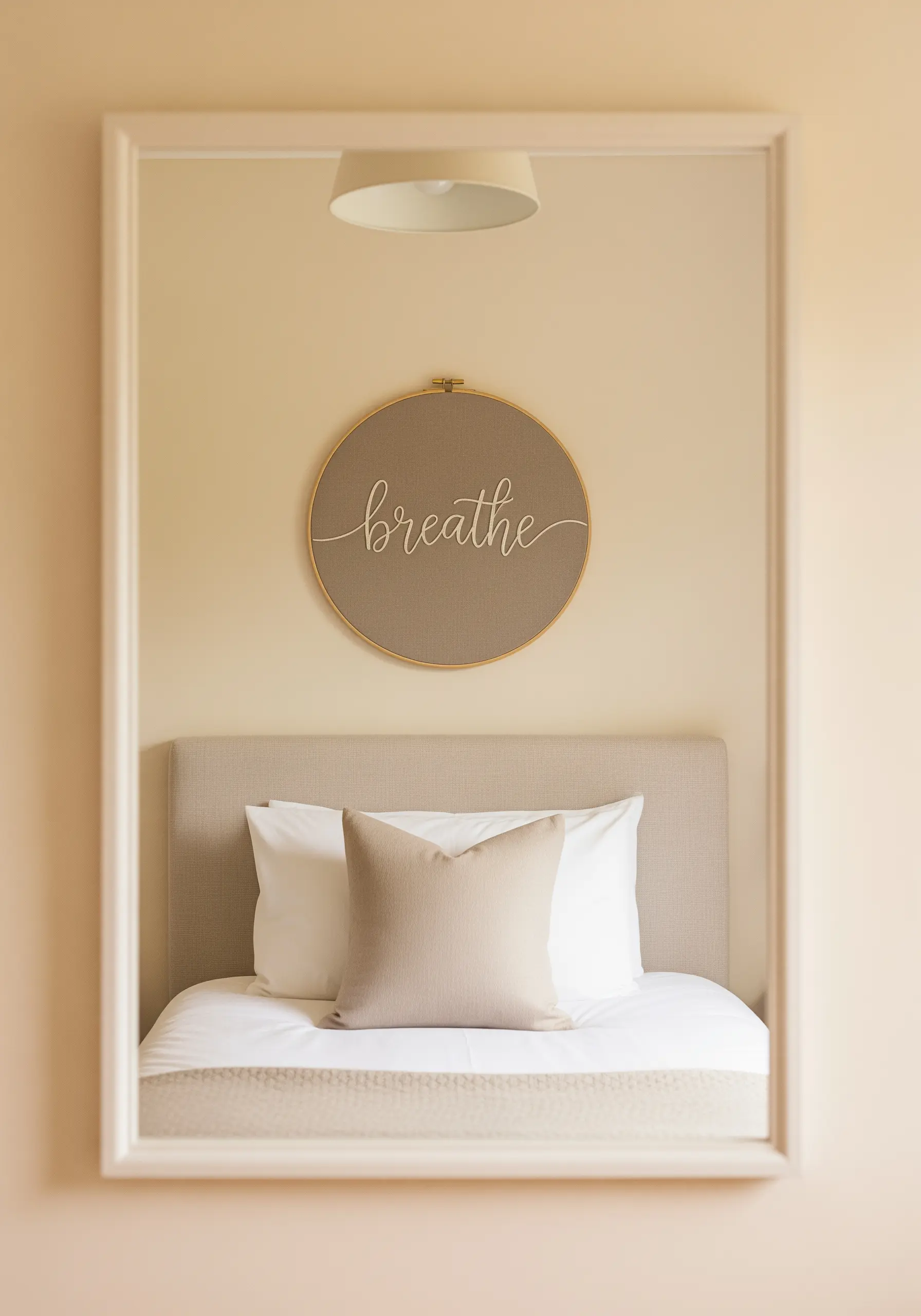 The word 'breathe' embroidered in smooth cursive script inside a hoop.