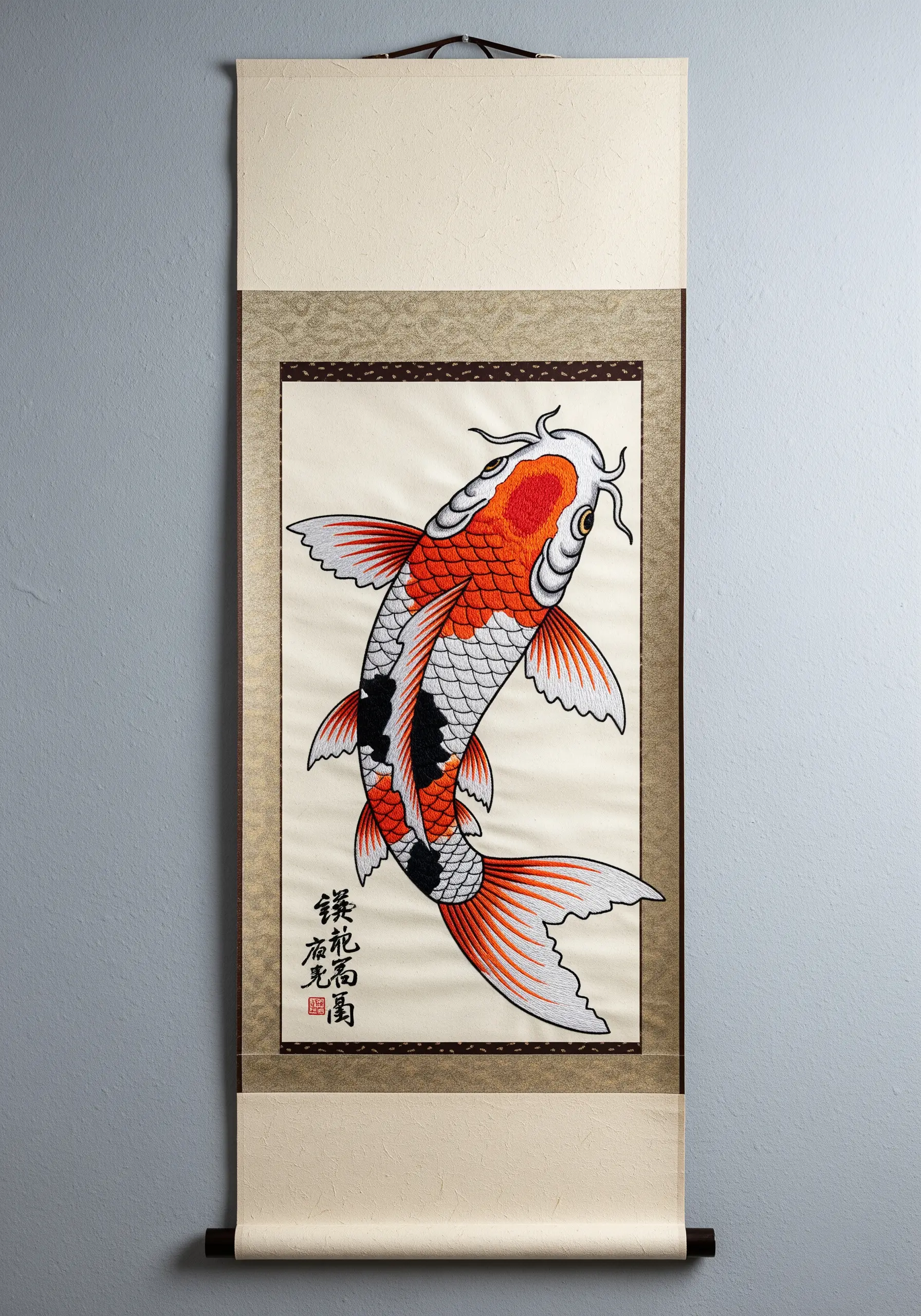 An intricately embroidered koi fish mounted on a traditional Japanese-style hanging paper scroll.