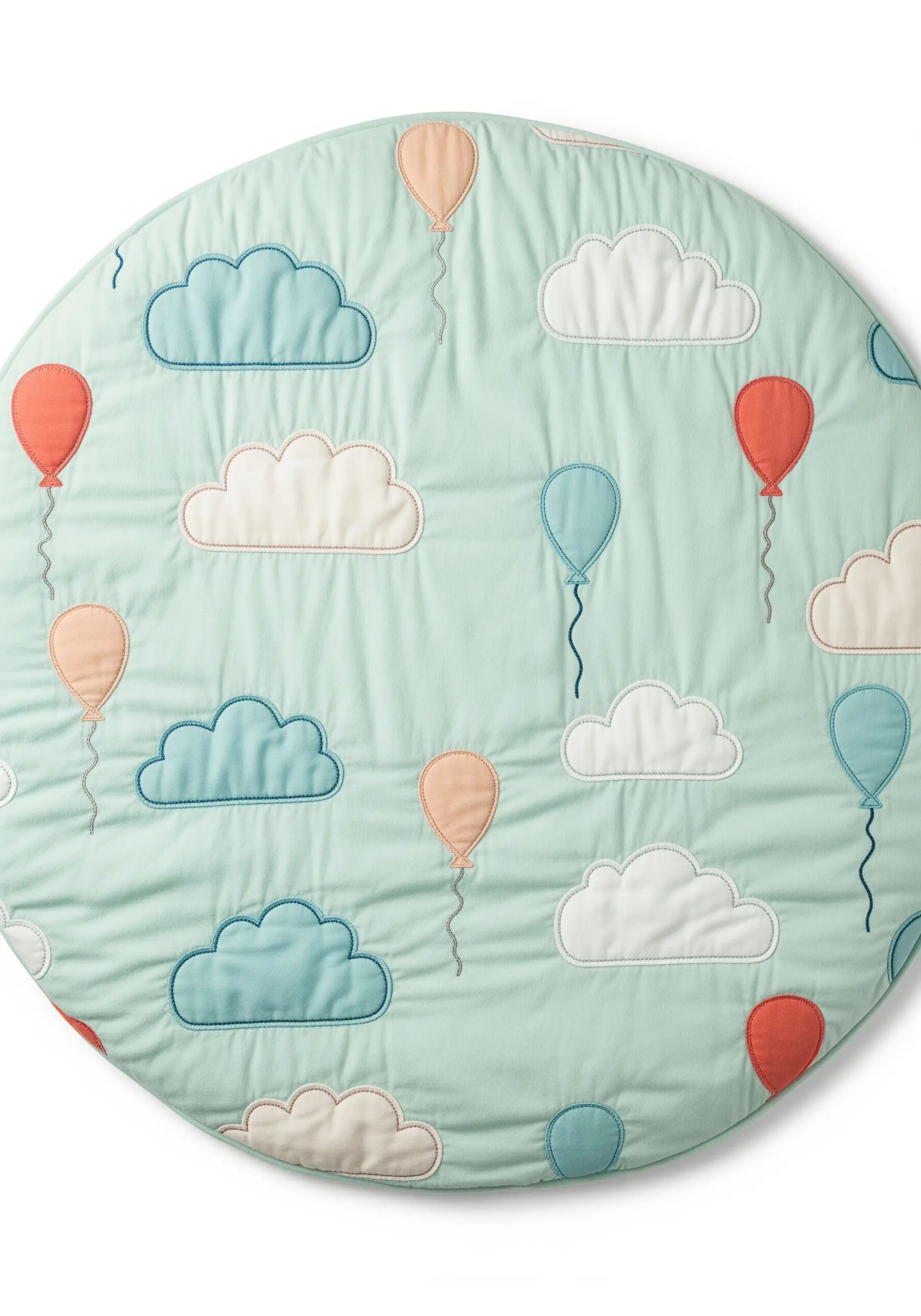 A quilted mint green play mat decorated with simple appliqué clouds and balloons.