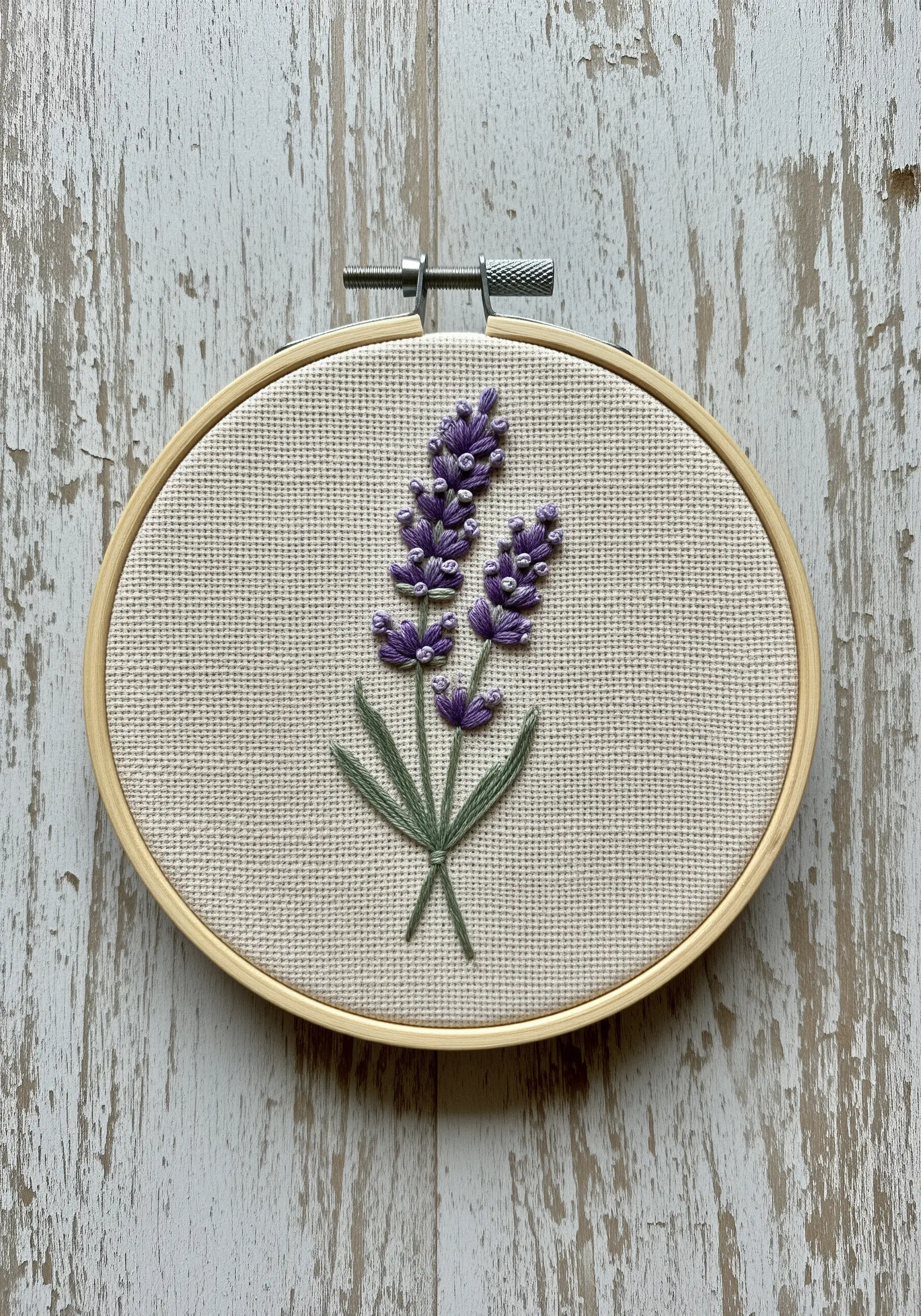 Embroidered lavender sprig with purple French knots on Aida cloth.