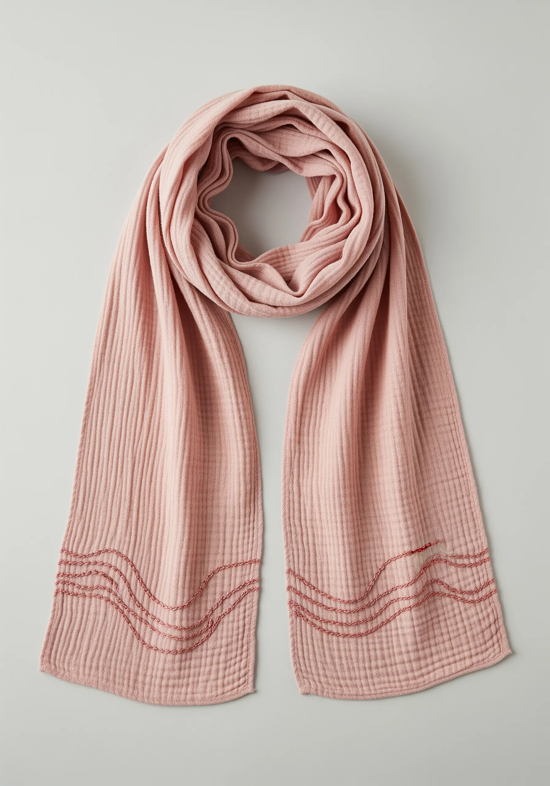 Abstract wavy border stitched with running stitch on a pink gauze scarf.