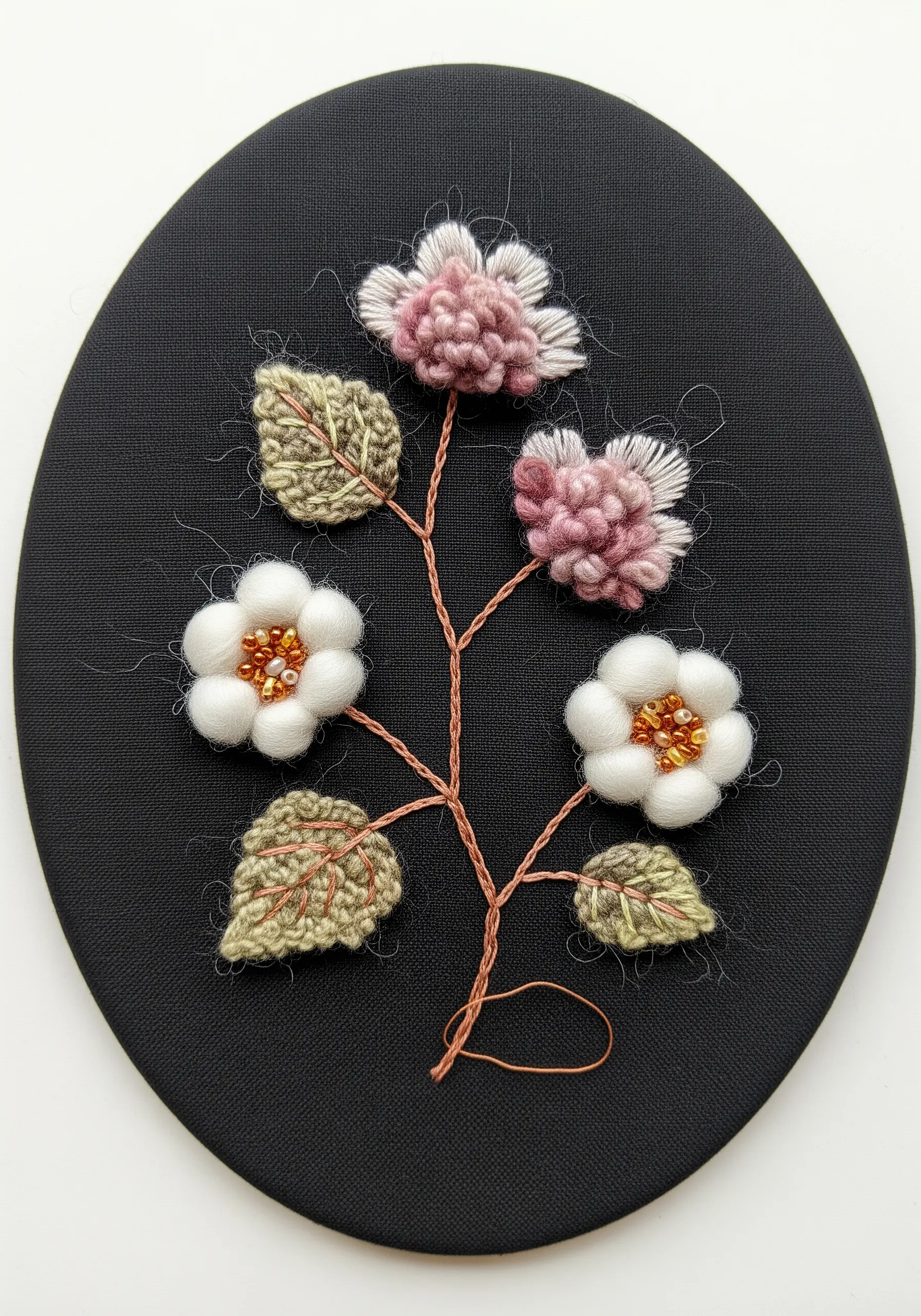 3D embroidered and crocheted flowers with bead centers on a black oval background.