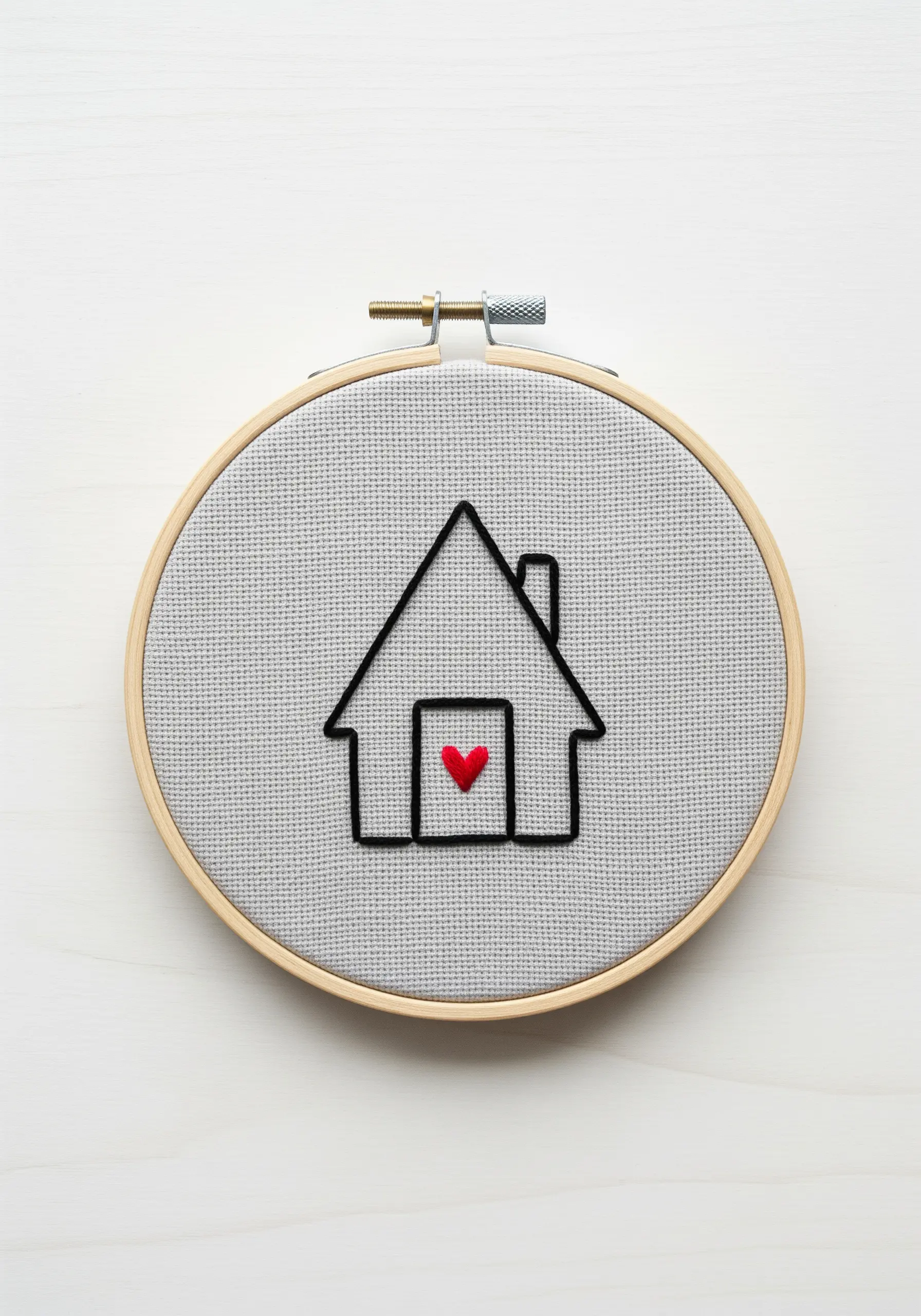 Minimalist outline of a house with a small, red satin-stitched heart.