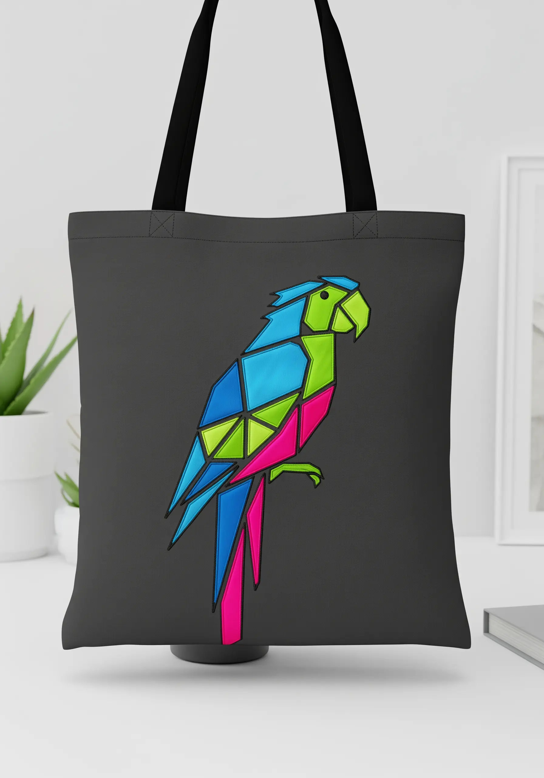 A geometric, low-poly style parrot embroidered in bright blue, green, and pink shapes.