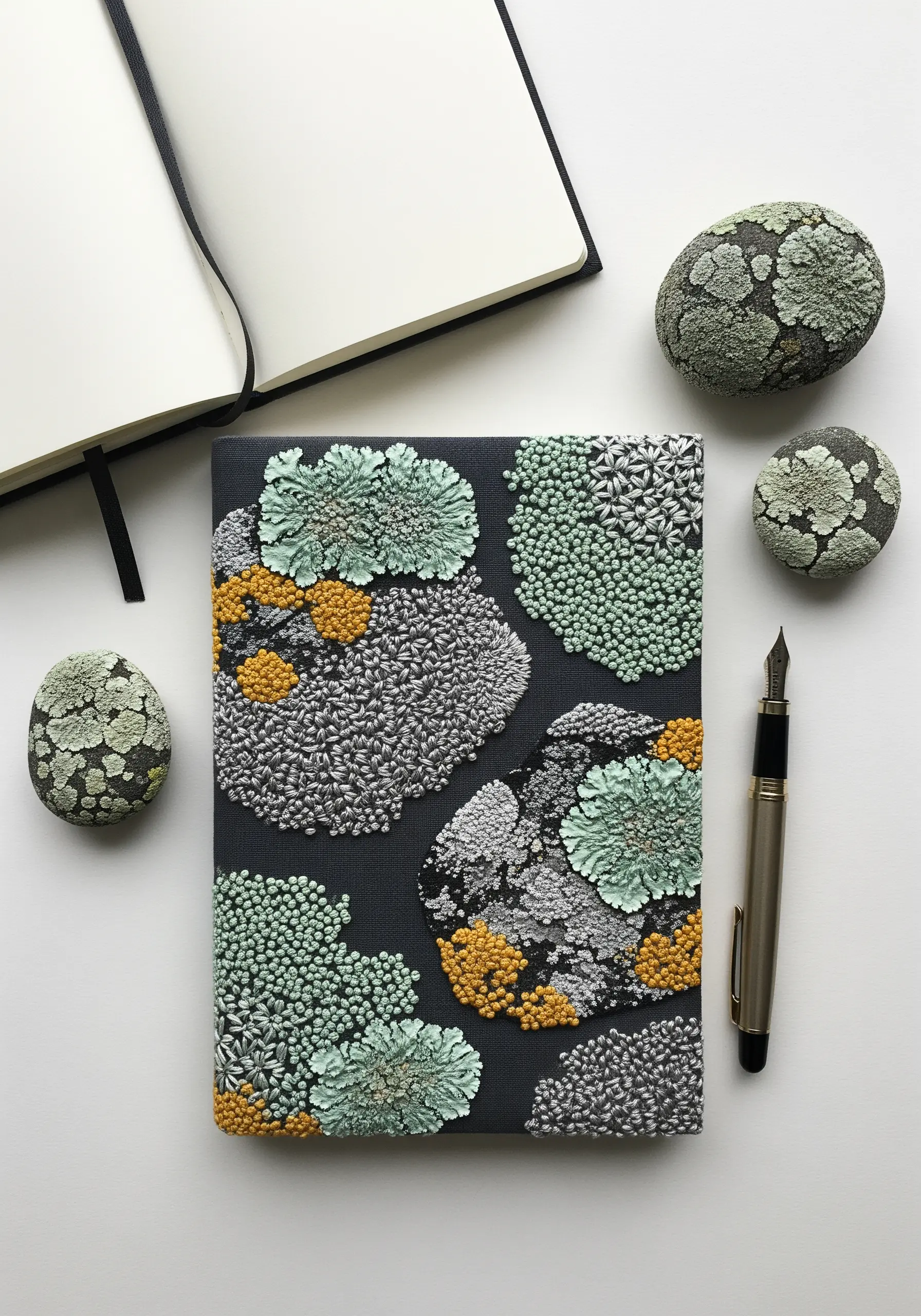 A journal cover decorated with dense clusters of French knots that look like lichen.