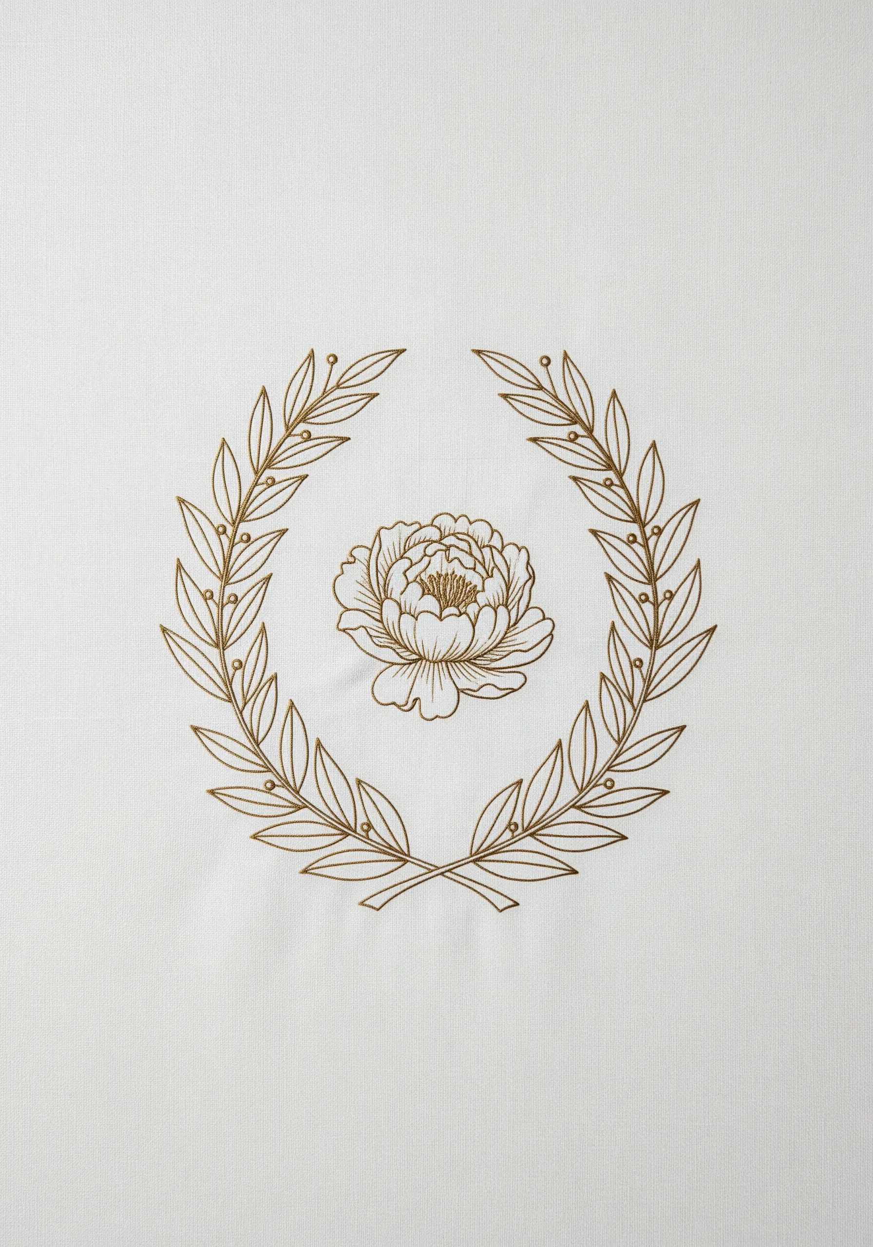 Gold embroidery of a peony flower centered within a classic laurel wreath.