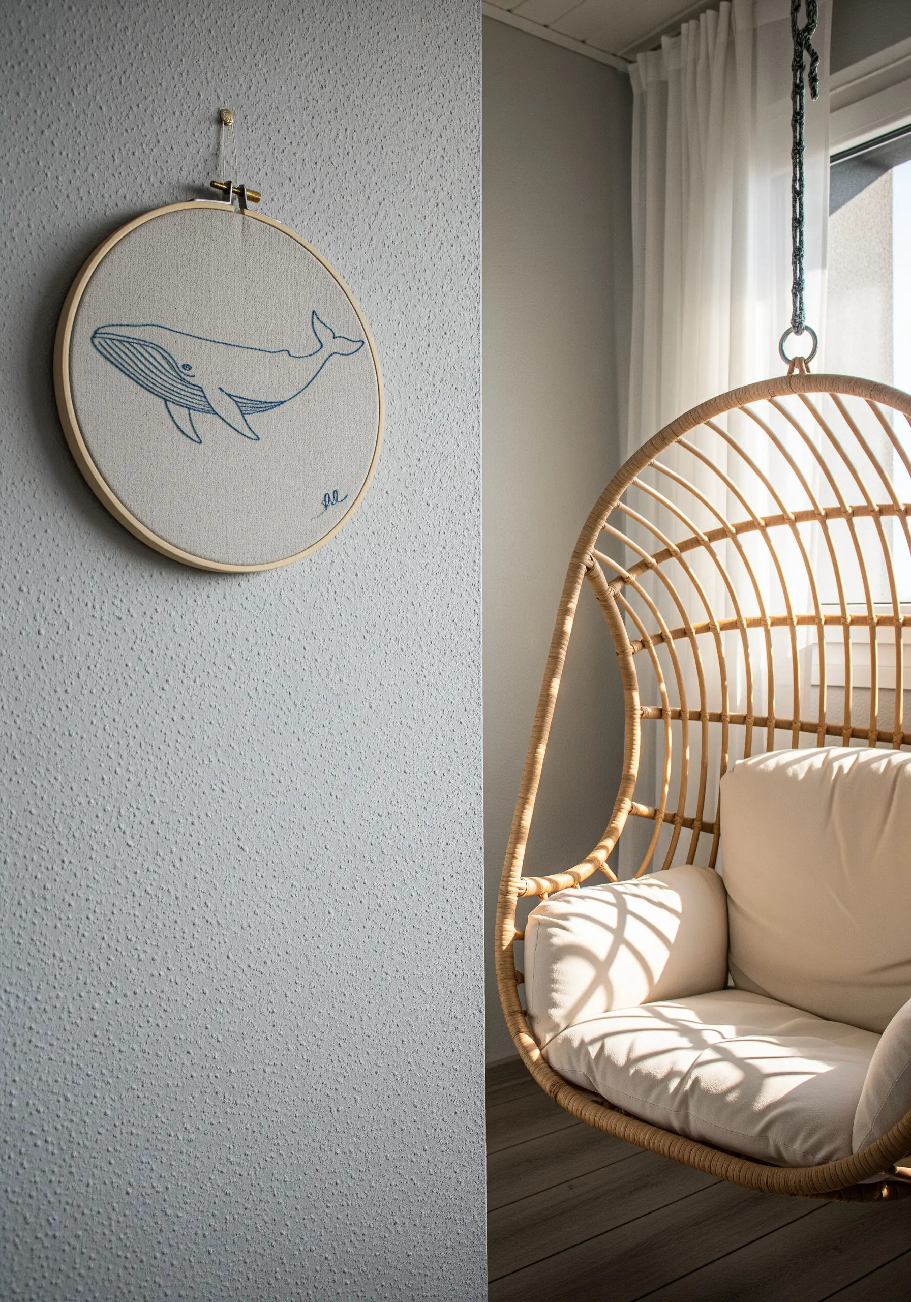 Minimalist line art embroidery of a whale in a large hoop.