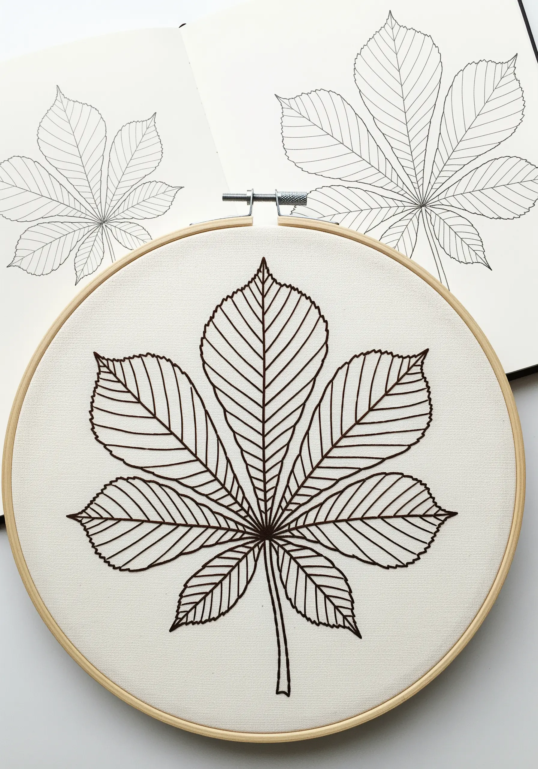 A complex horse chestnut leaf rendered in a clean, continuous dark brown outline stitch.