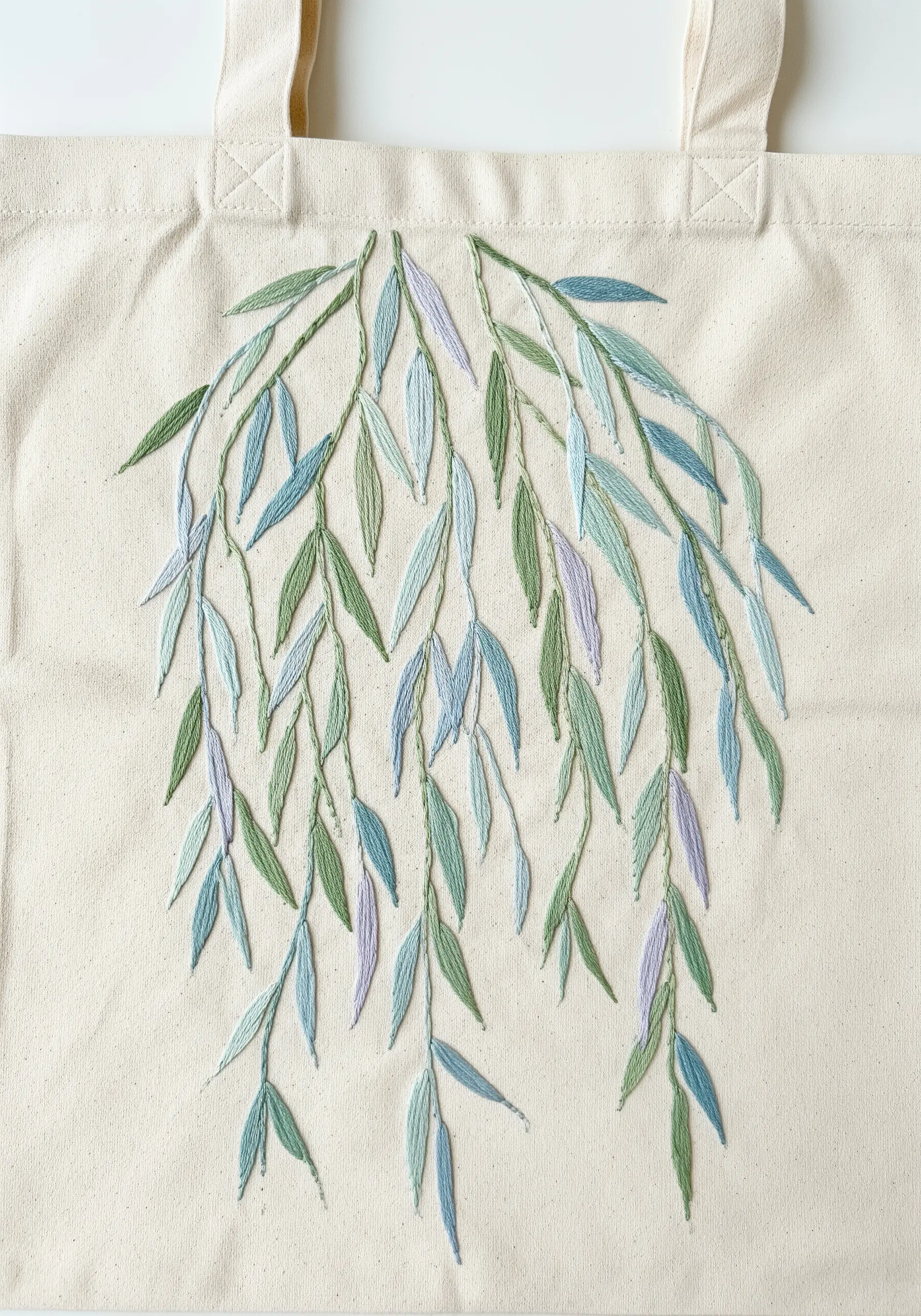 Cascading willow leaves embroidered in cool tones of green, blue, and lavender.