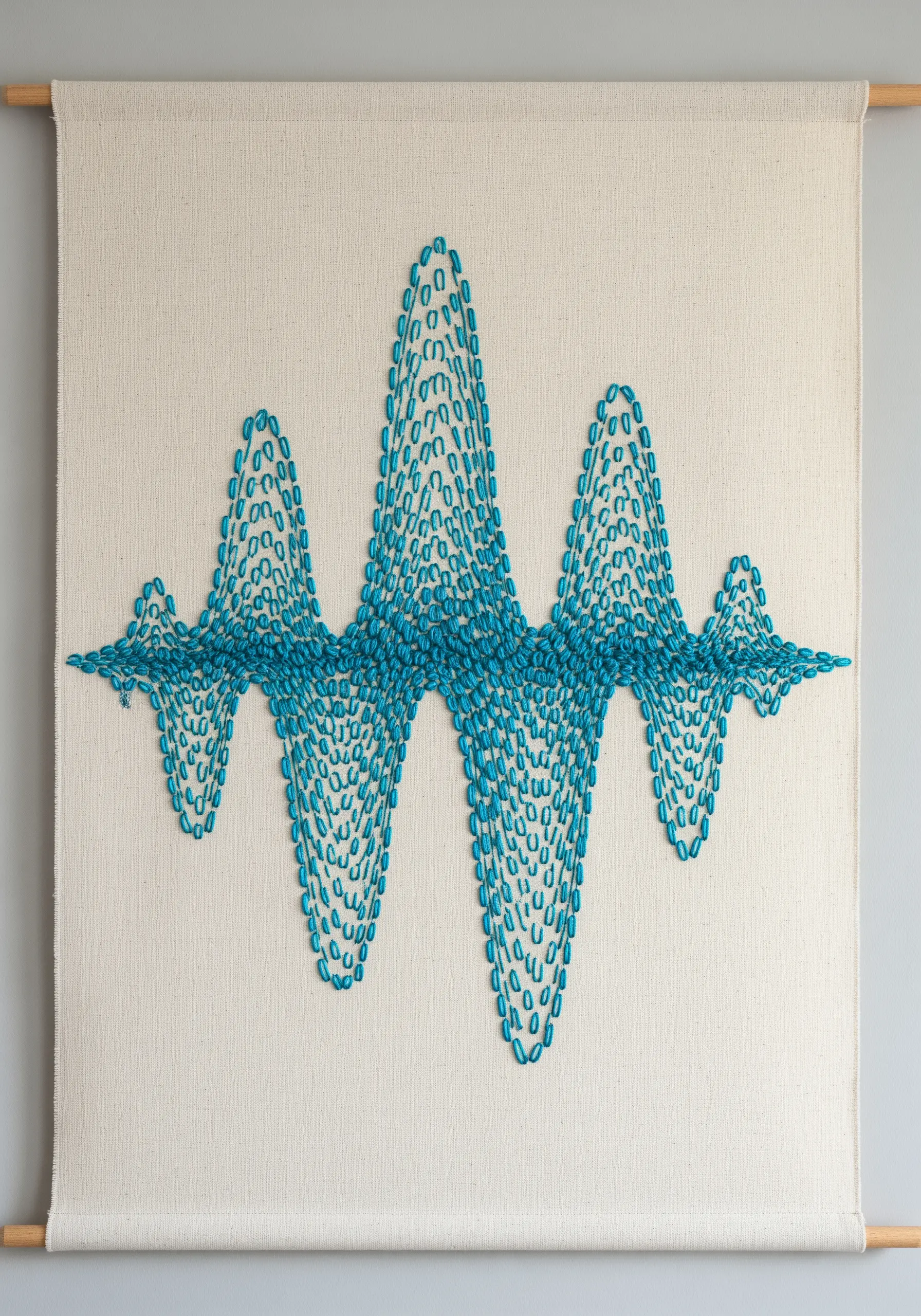 An abstract soundwave pattern embroidered with blue detached chain stitches on a wall hanging.