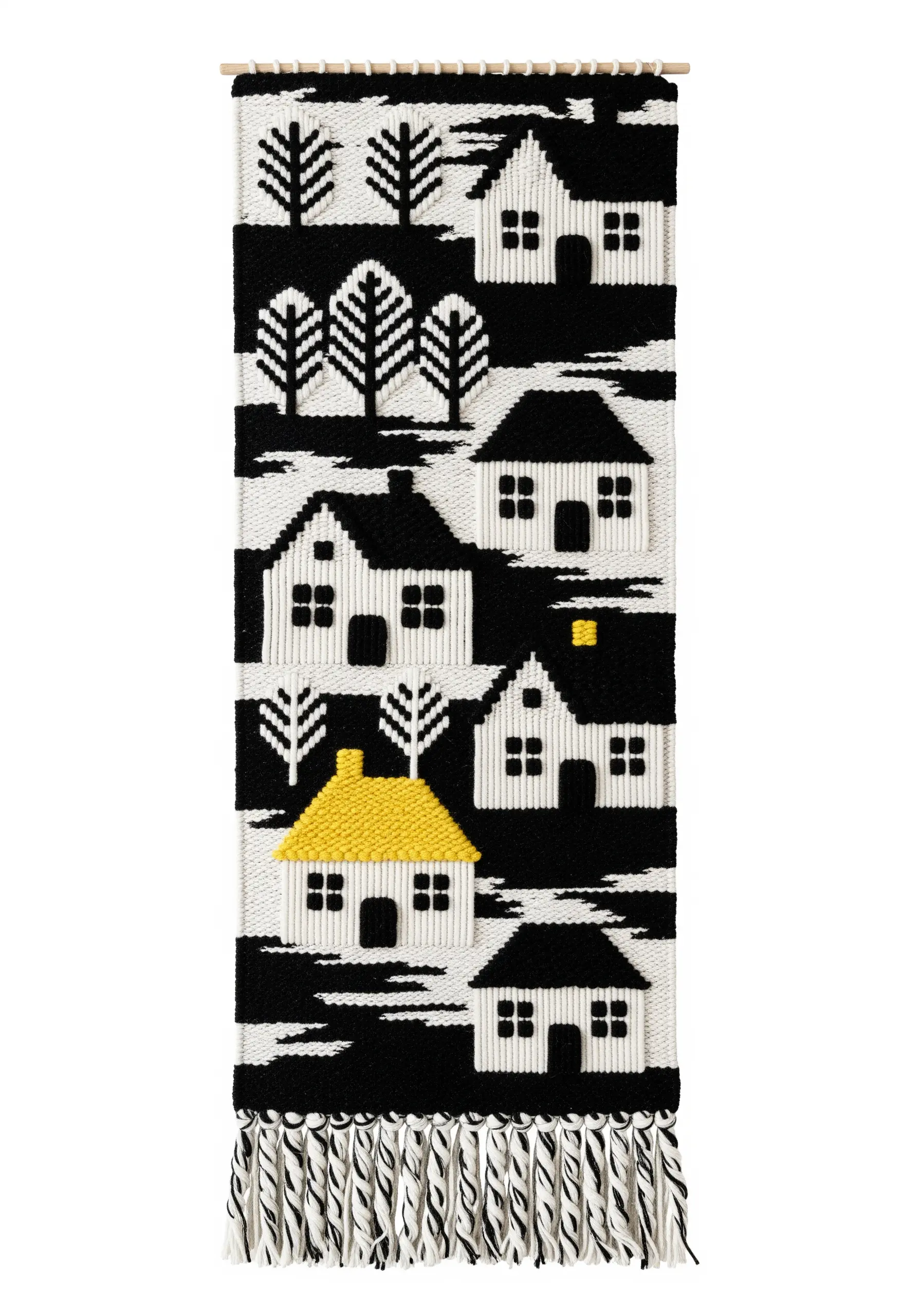 A black-and-white woven wall hanging depicting a village scene, with one house having a bright yellow roof.