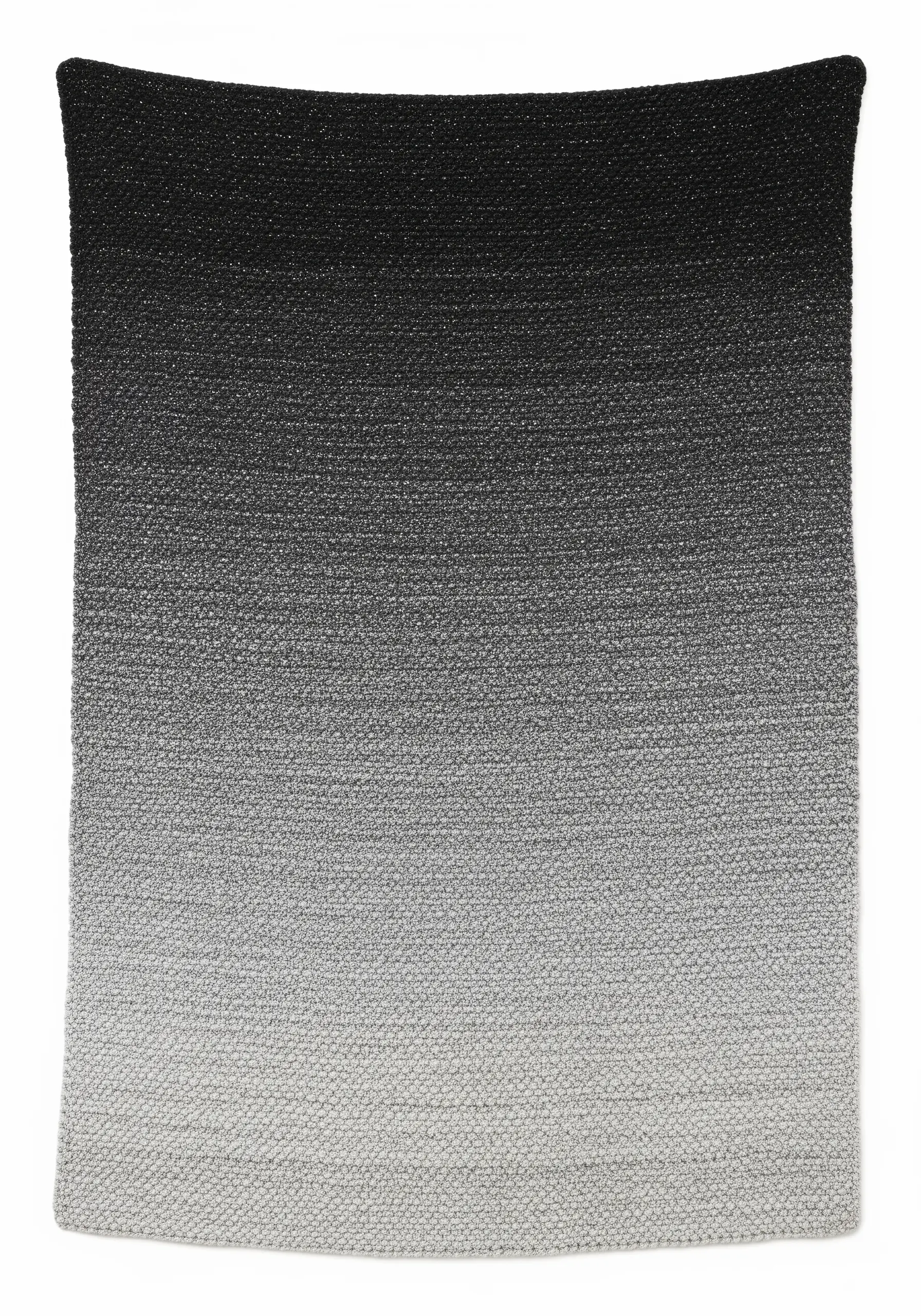 A woven textile with a perfectly smooth gradient from black to gray to white.