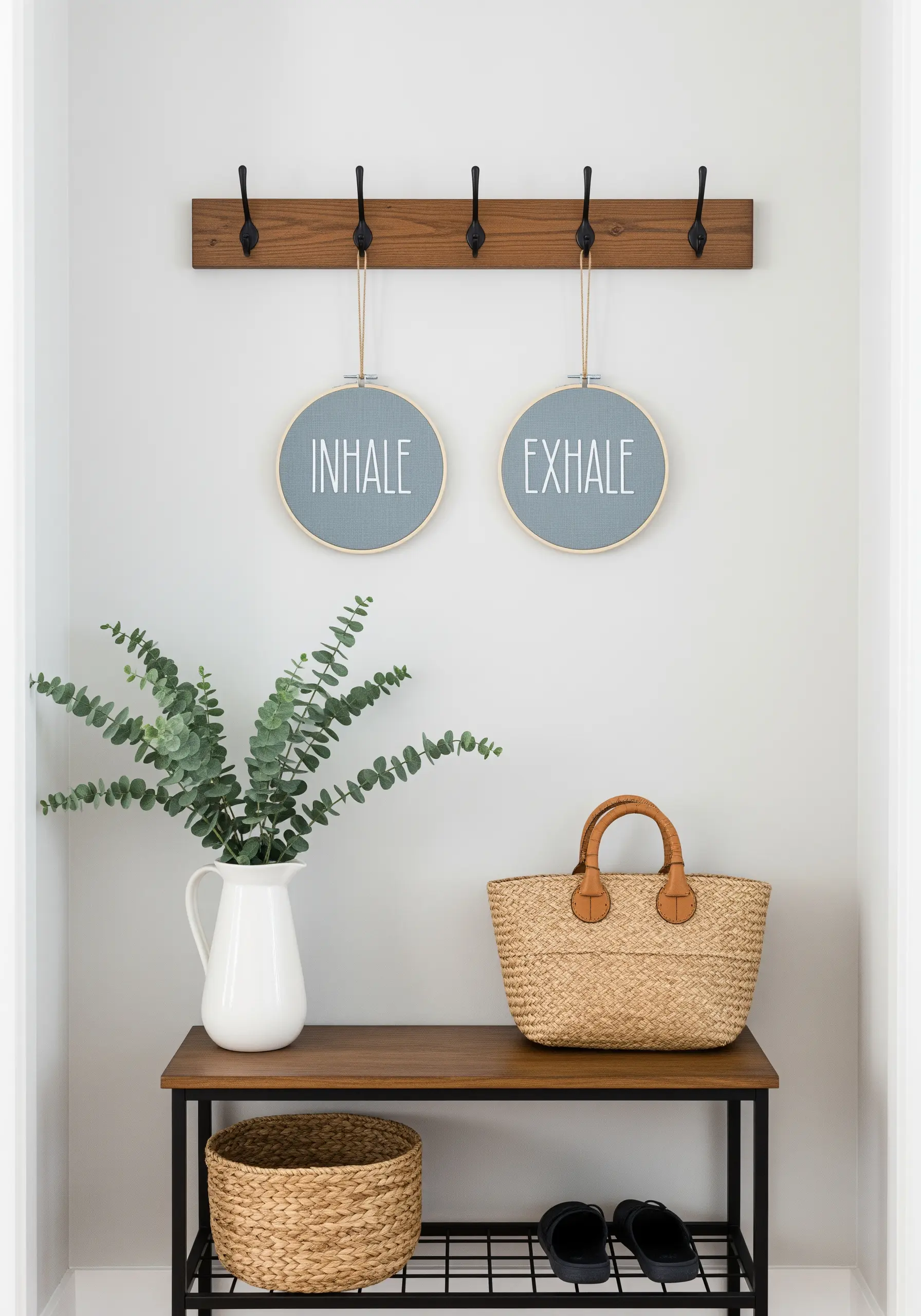 Two embroidery hoops with 'inhale' and 'exhale' created using negative space stitching.