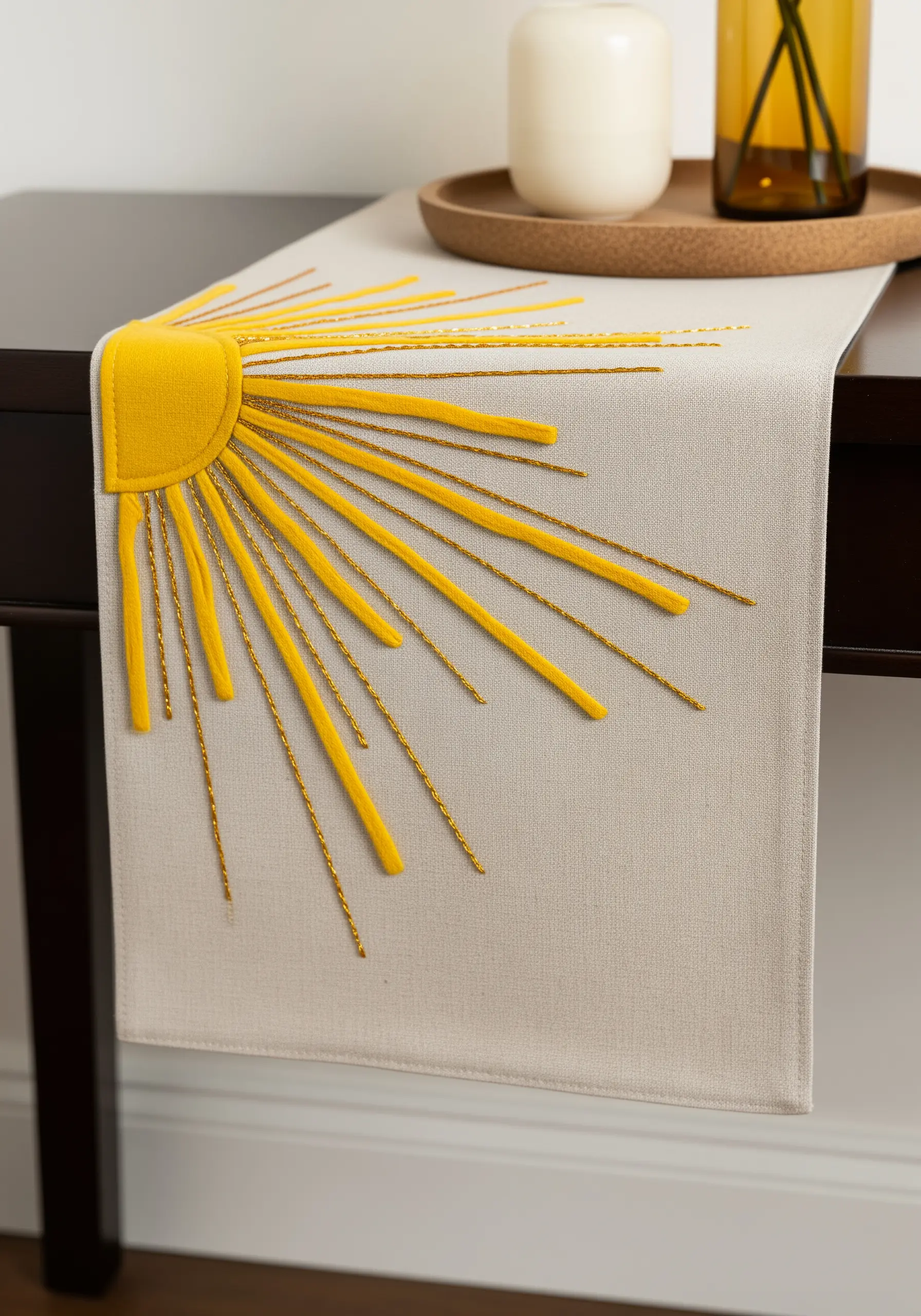A yellow appliqué sun with long embroidered rays in matte yellow and metallic gold thread.