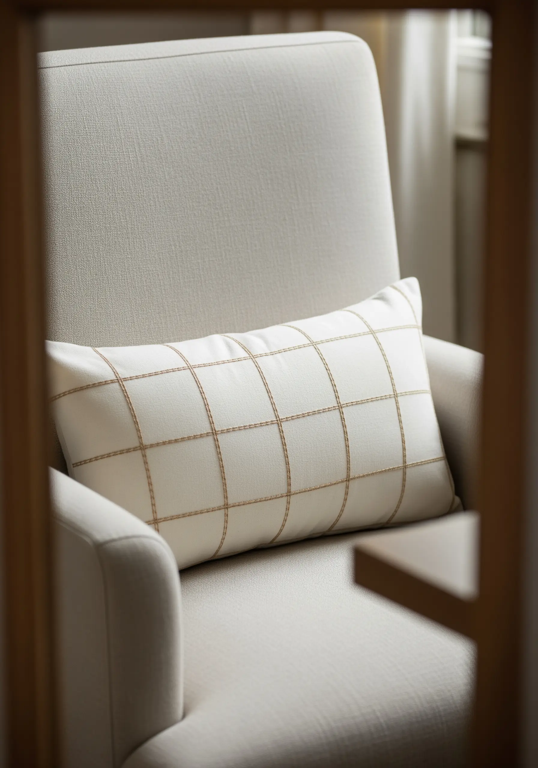 A lumbar pillow with a hand-stitched grid pattern in a contrasting thread.