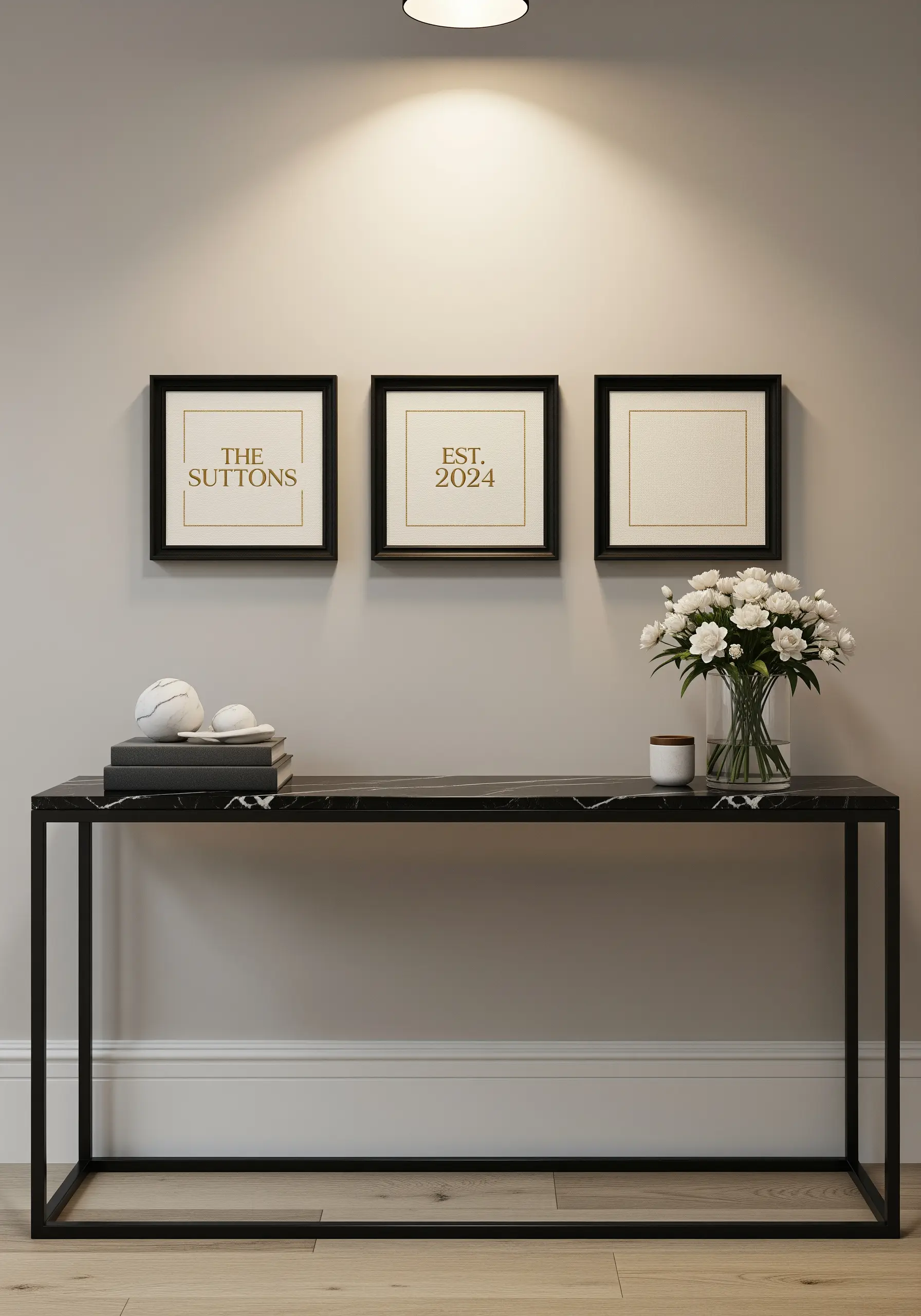 Three framed embroidery pieces with minimalist family name and date.