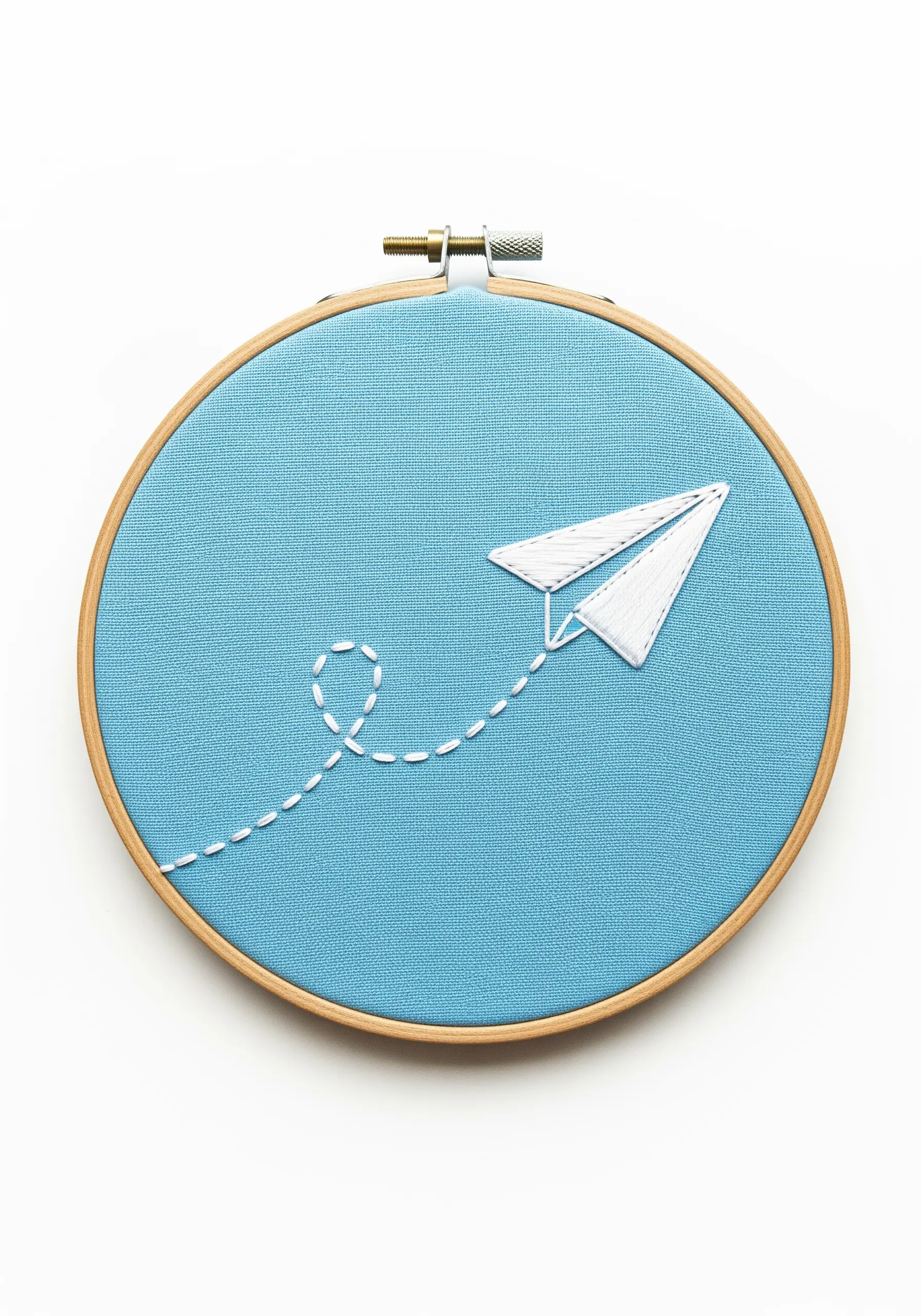 A perfectly smooth, satin-stitched paper airplane with a dotted trail.