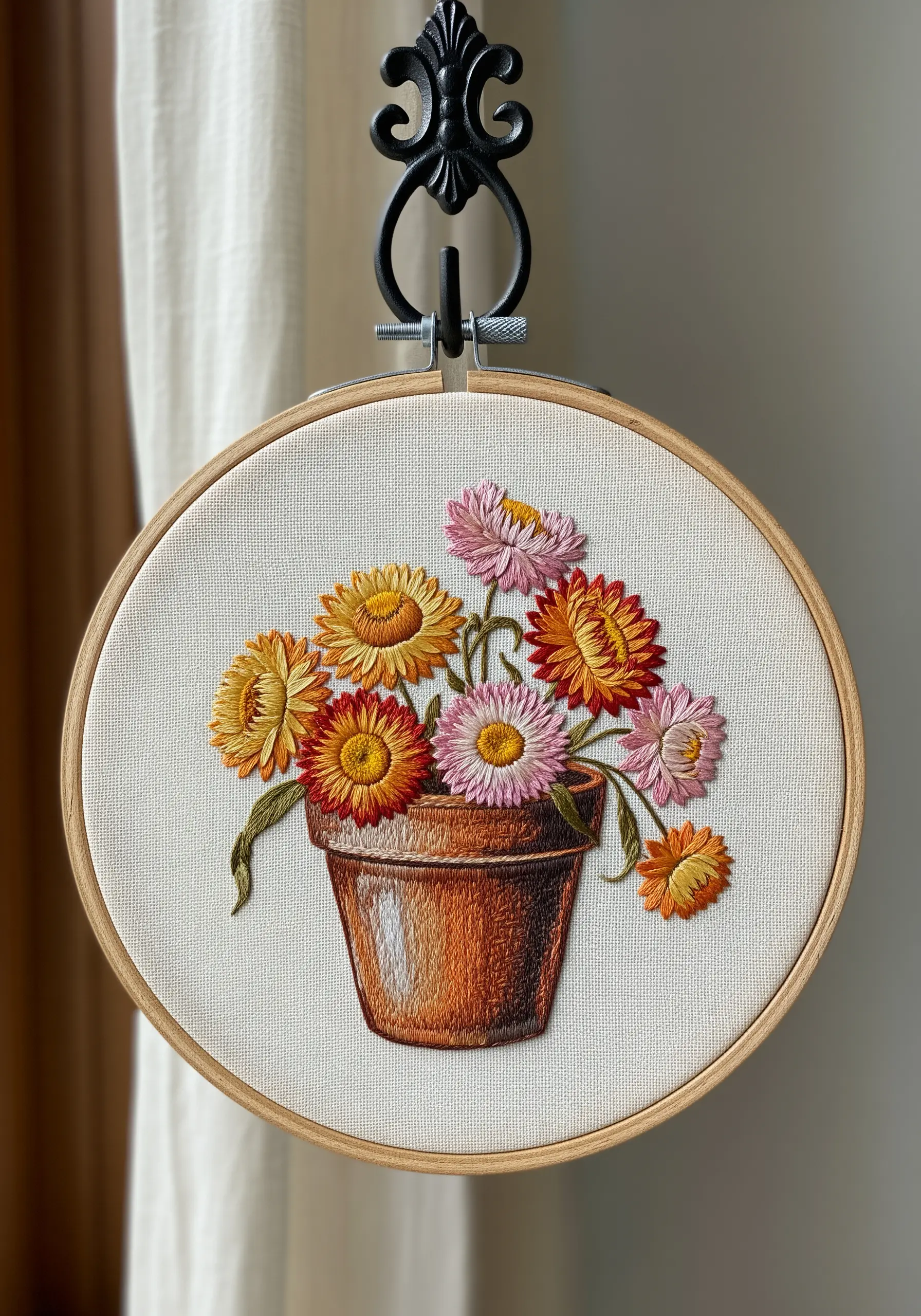 Thread-painted strawflowers in a terracotta pot with realistic color gradients