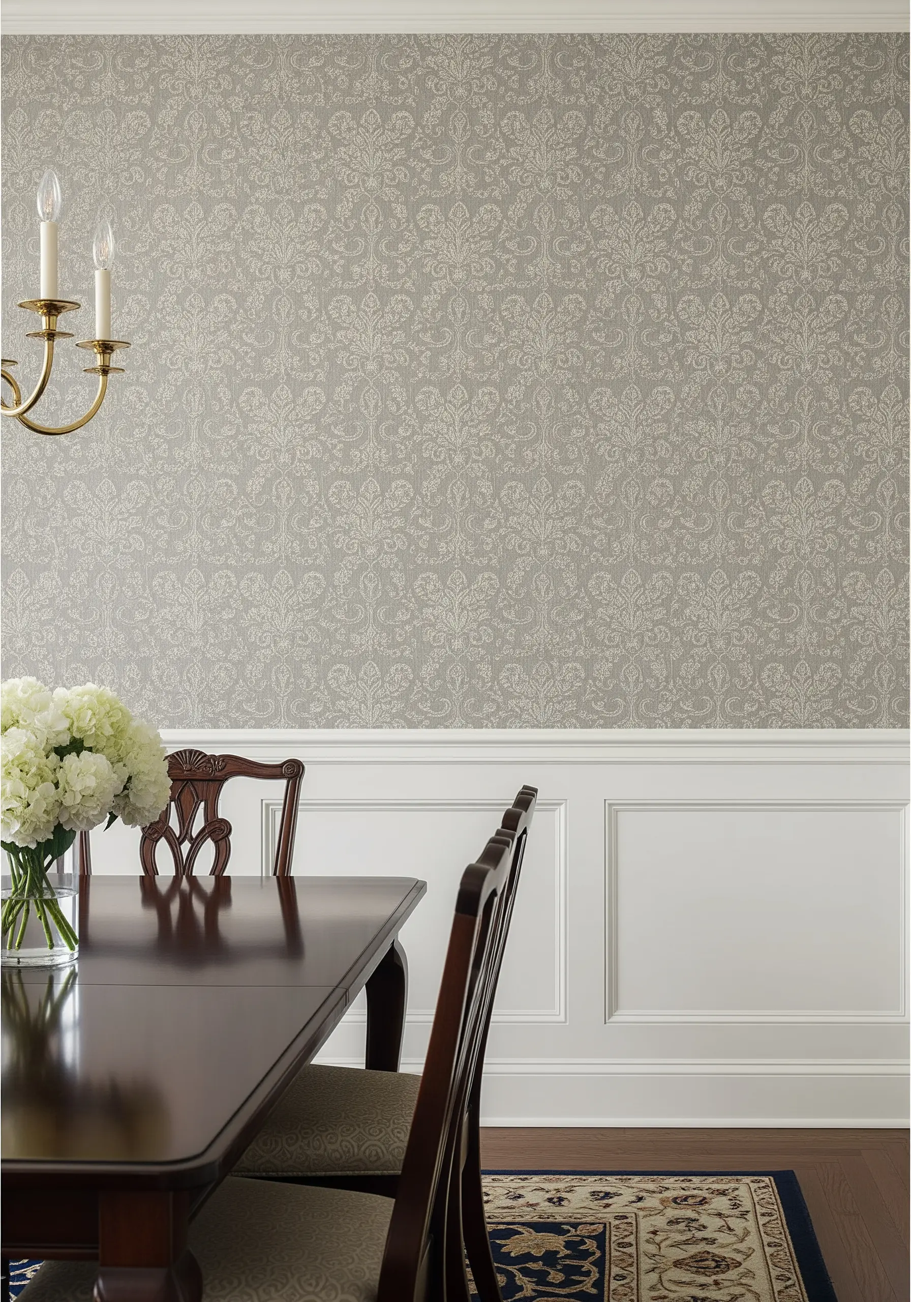 A wall covered in a subtle, tone-on-tone embroidered damask pattern in a neutral gray color