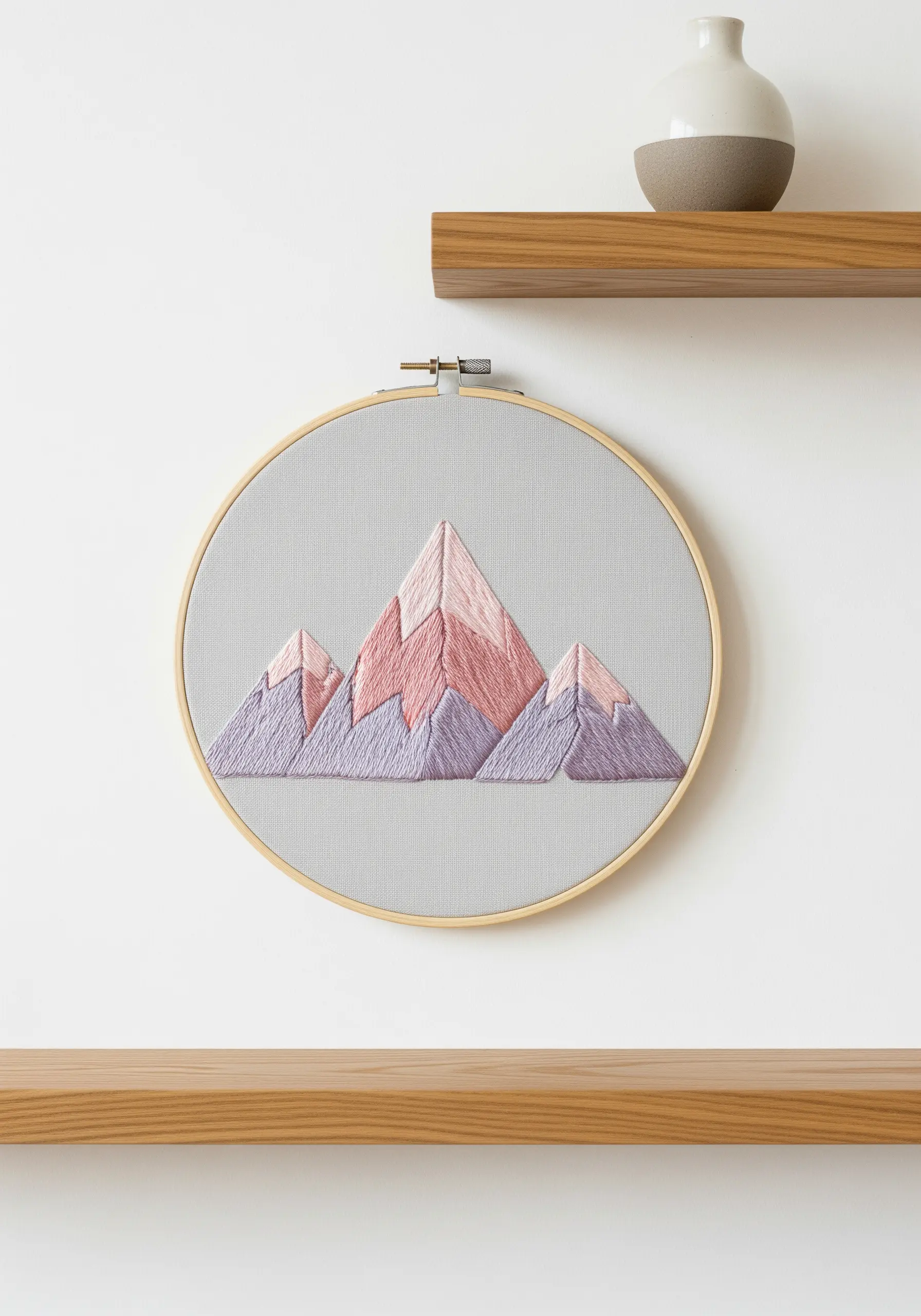 Geometric mountain range with pink and purple satin stitch embroidery.