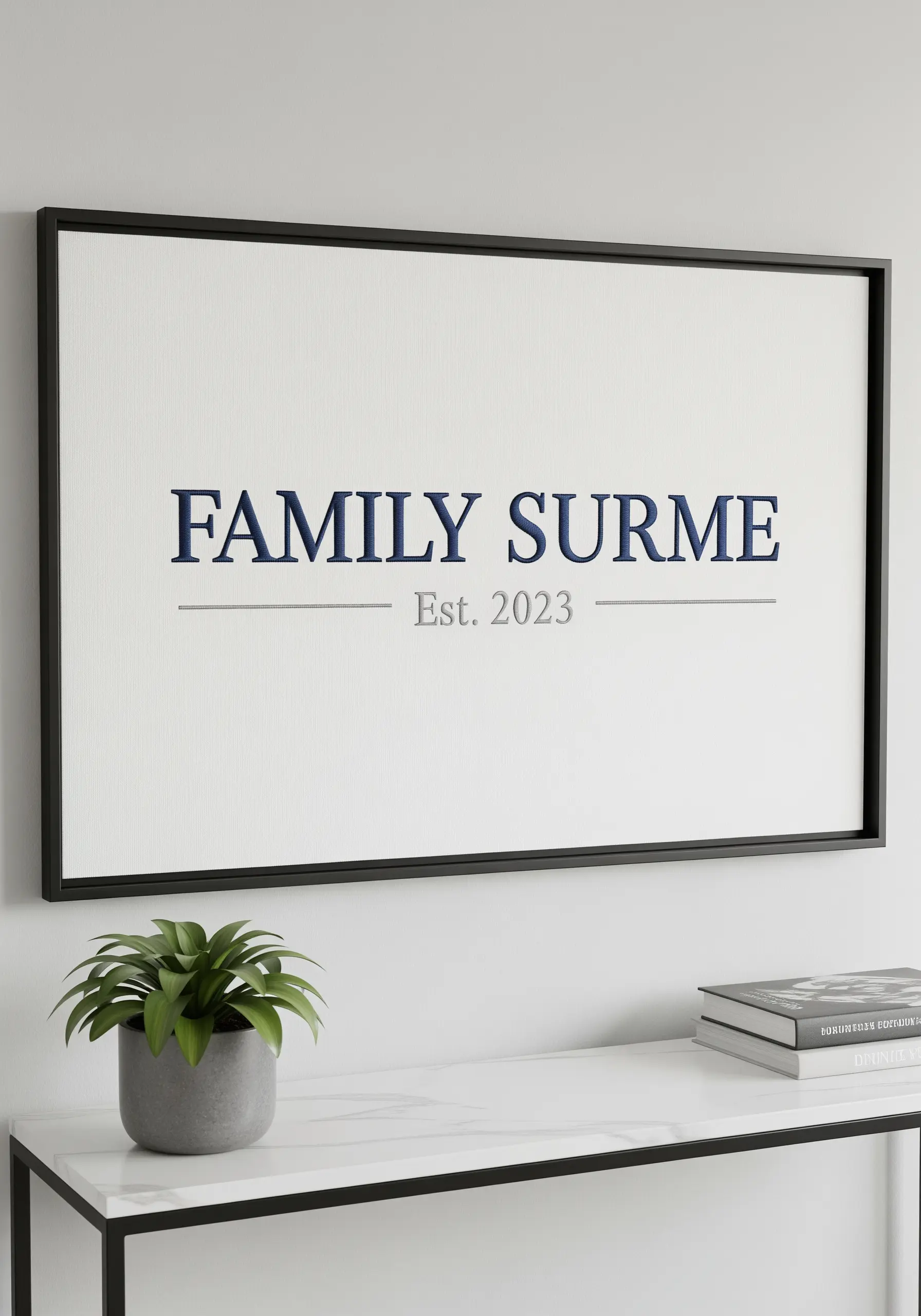 A framed family surname embroidered in a clean, formal navy blue font.