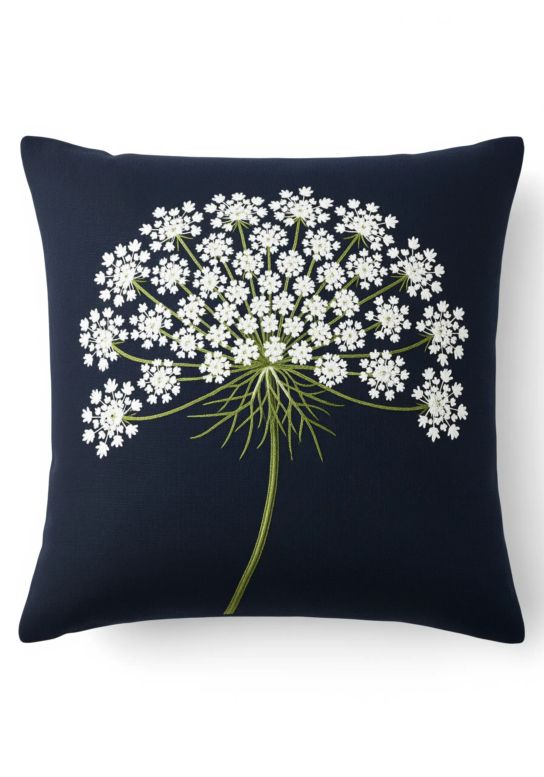 Intricate white Queen Anne's lace embroidered against a solid dark navy pillow.