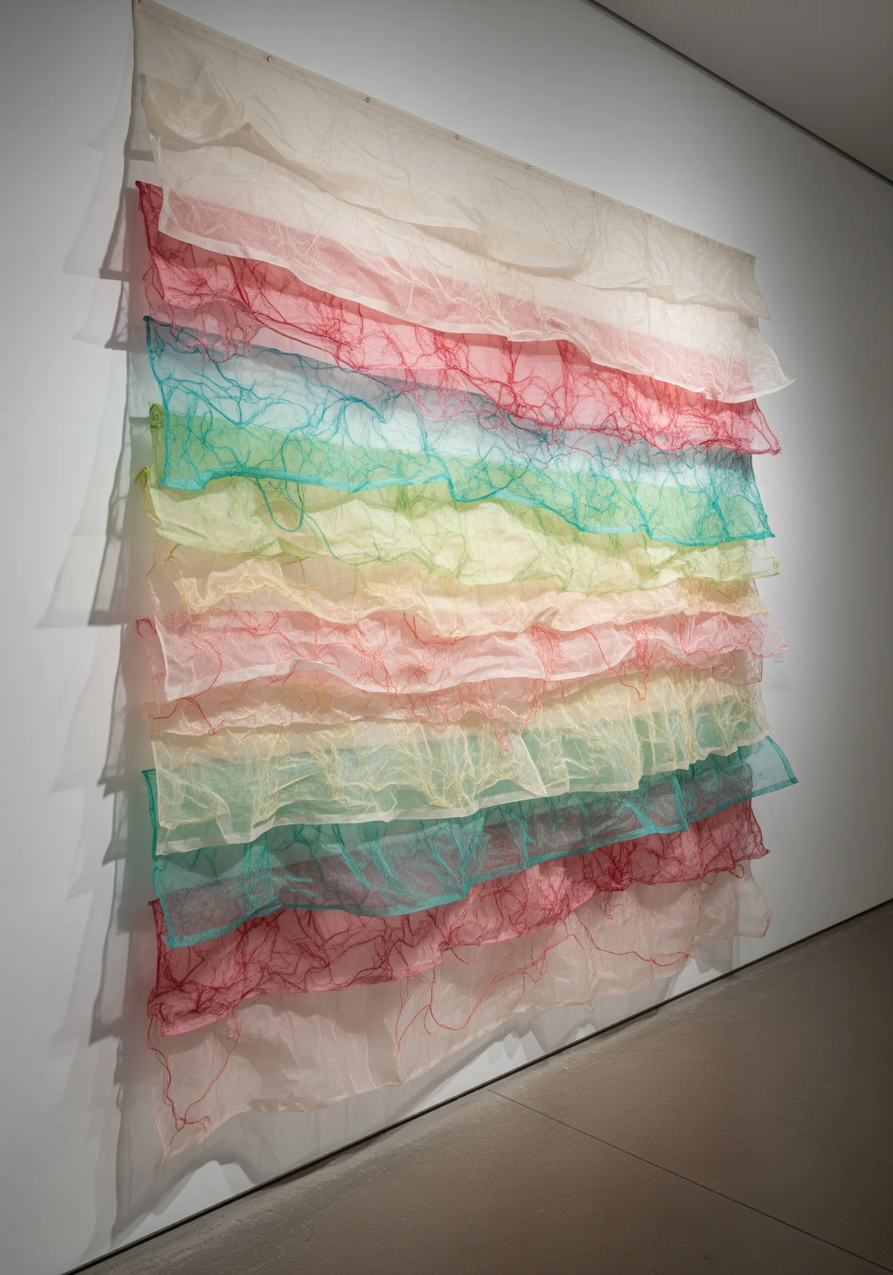 Layered sheer fabric with colorful free-motion machine embroidery.