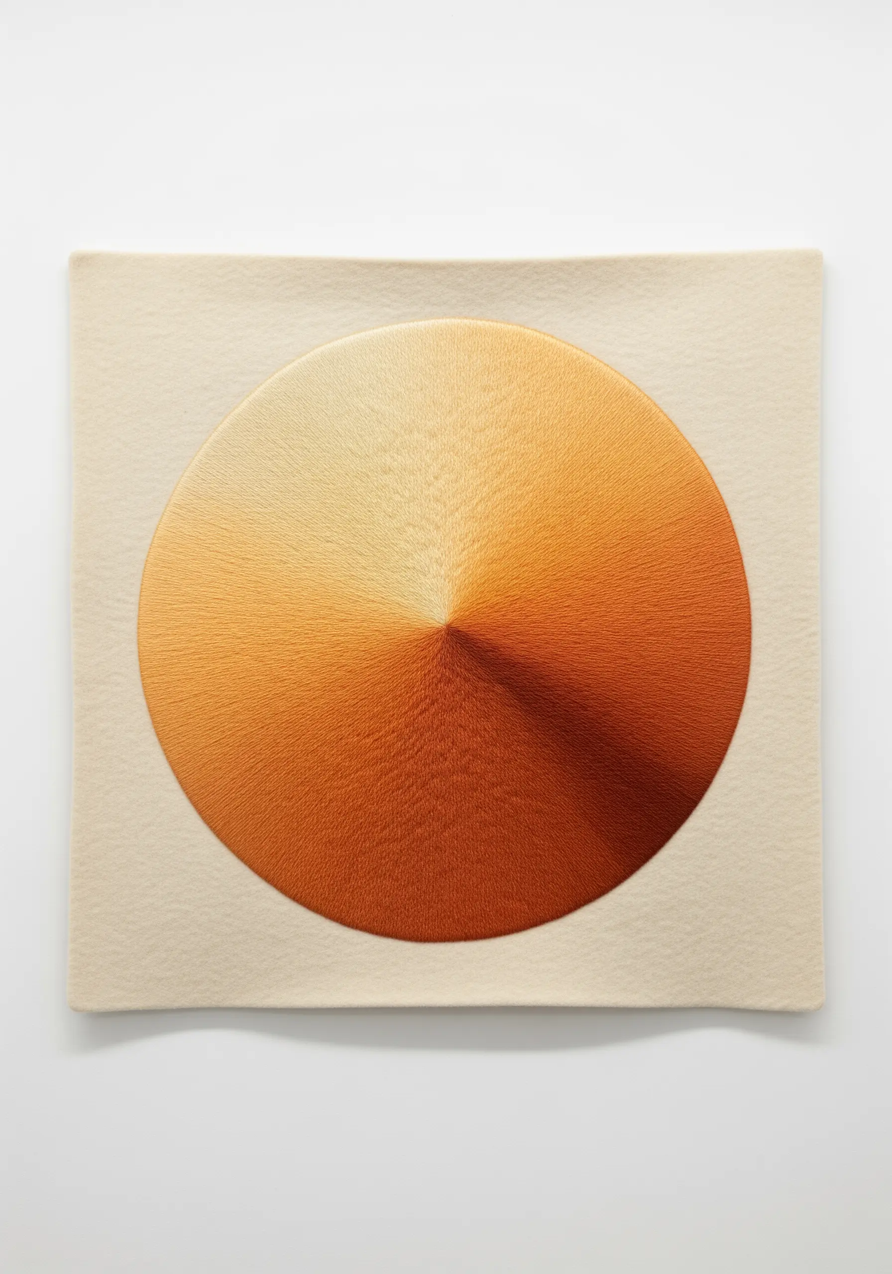 A perfect circle of radial satin stitch blending from light to dark orange.