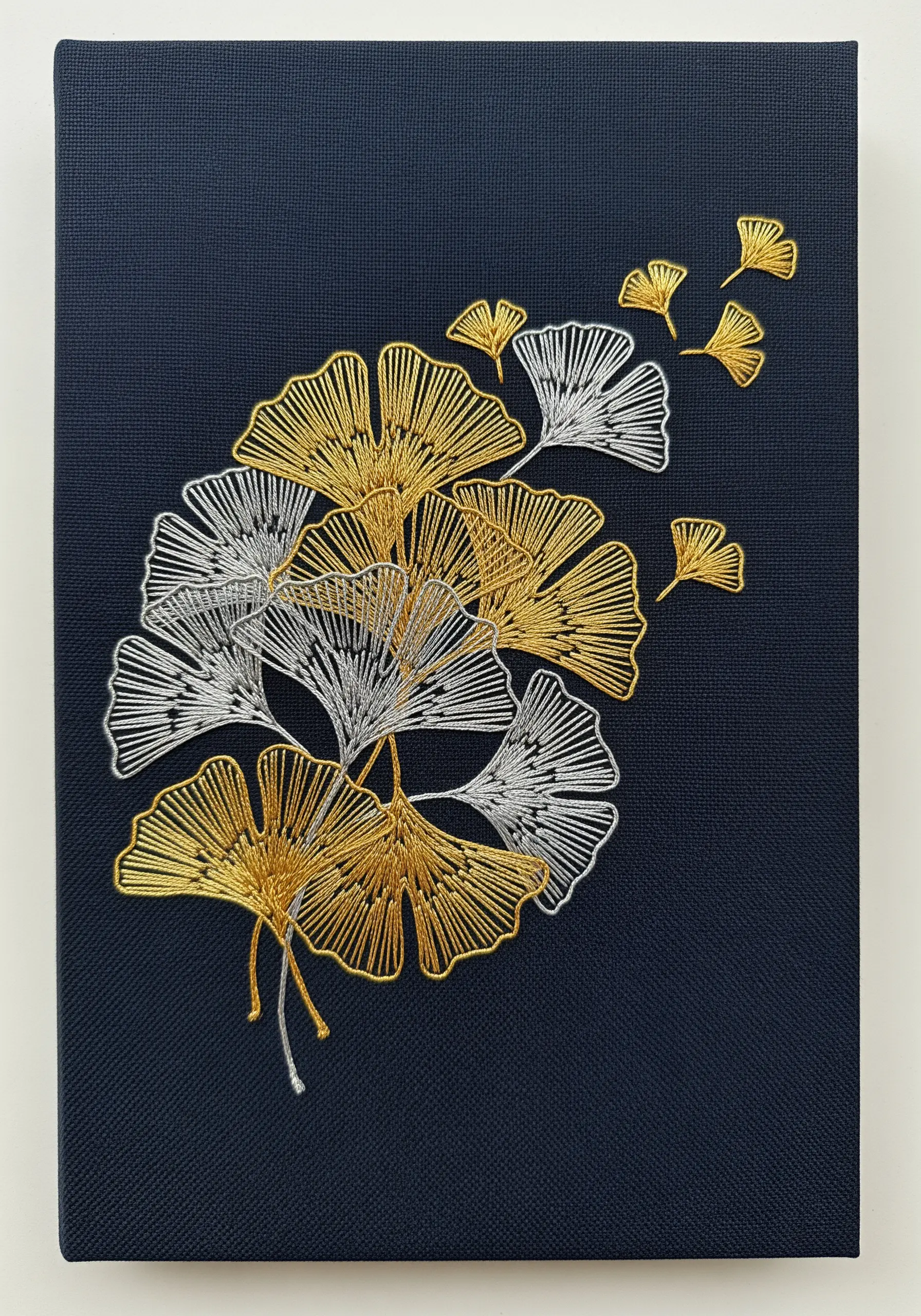 Gold and silver metallic thread ginkgo leaves on dark navy canvas