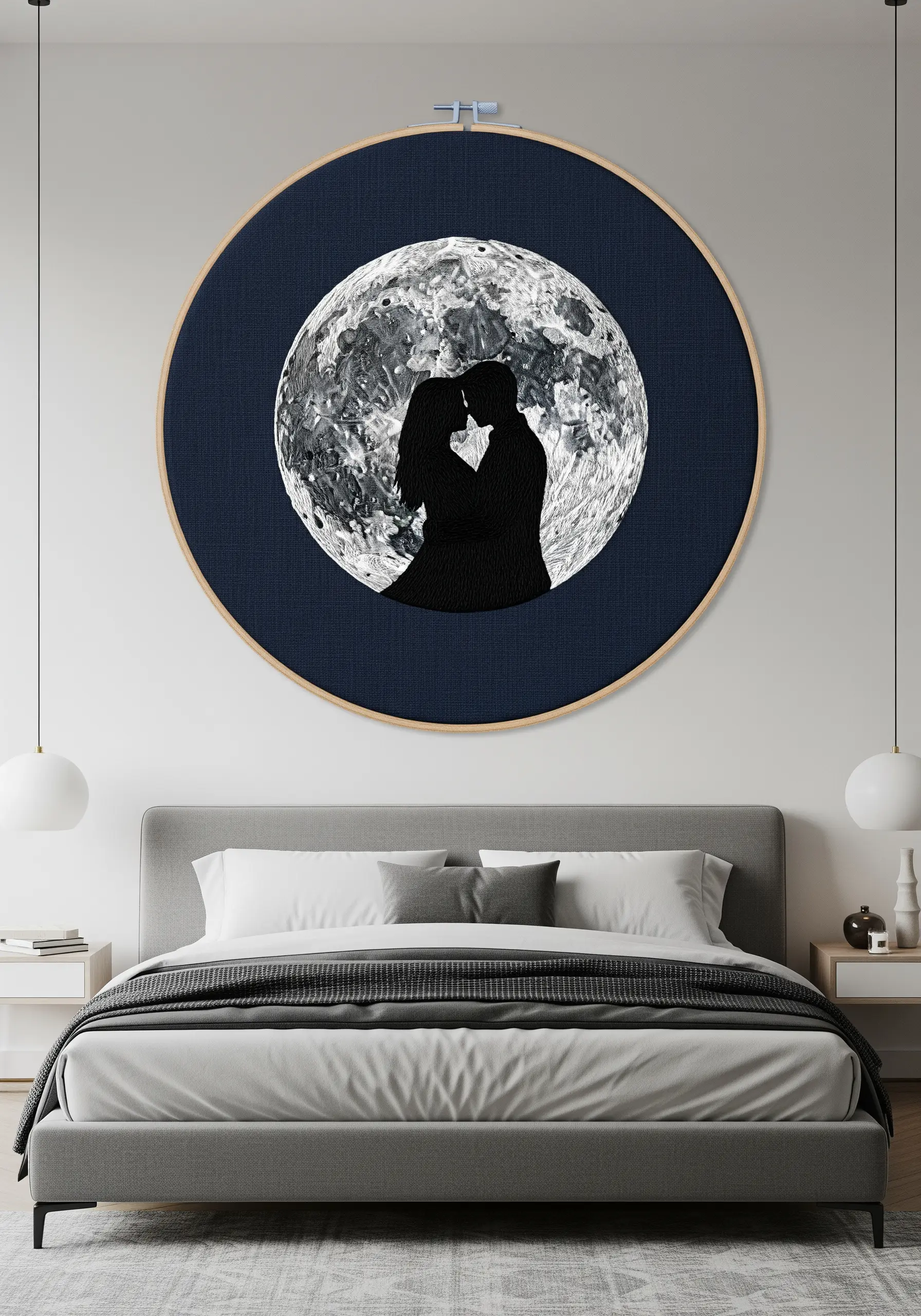 A solid black couple silhouette against a hyper-realistic, thread-painted full moon.