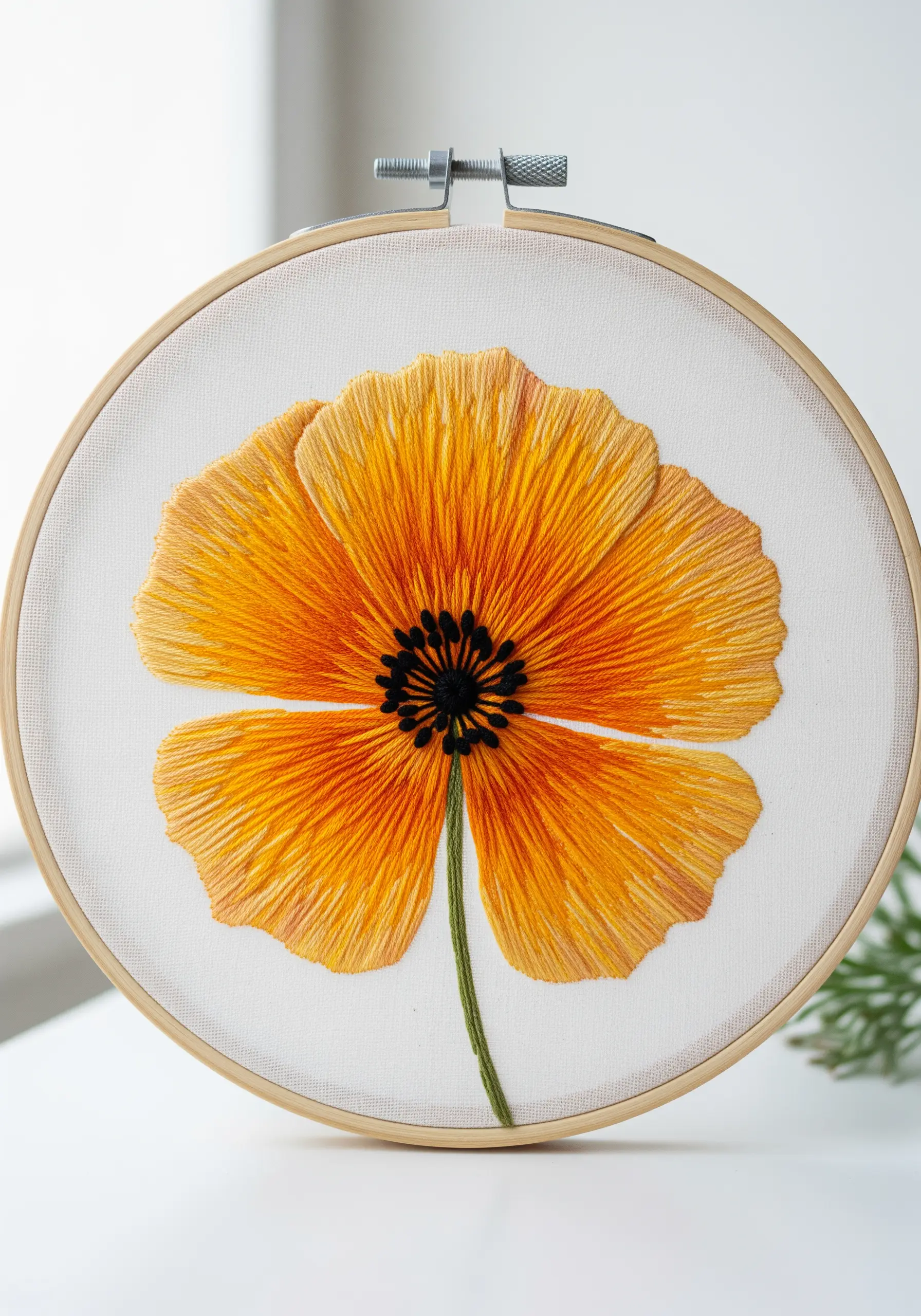 A vibrant orange California poppy with long, radiant stitches creating a translucent effect.