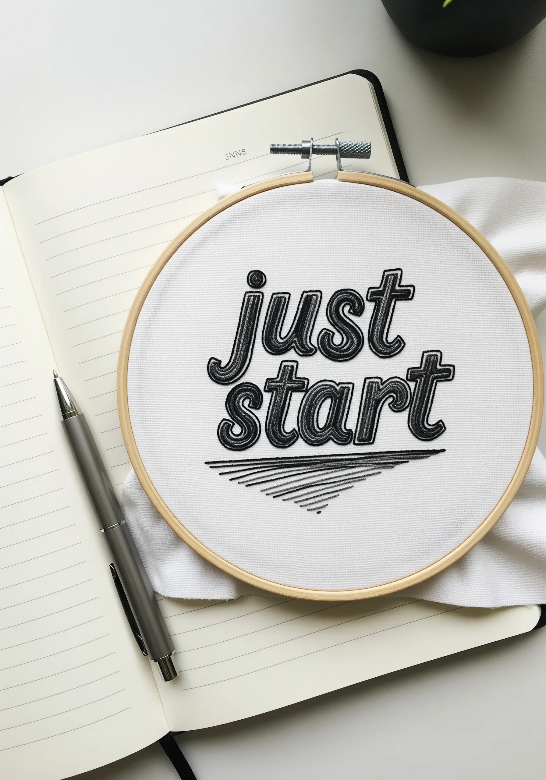 Graphic 'just start' embroidery with a black drop shadow effect